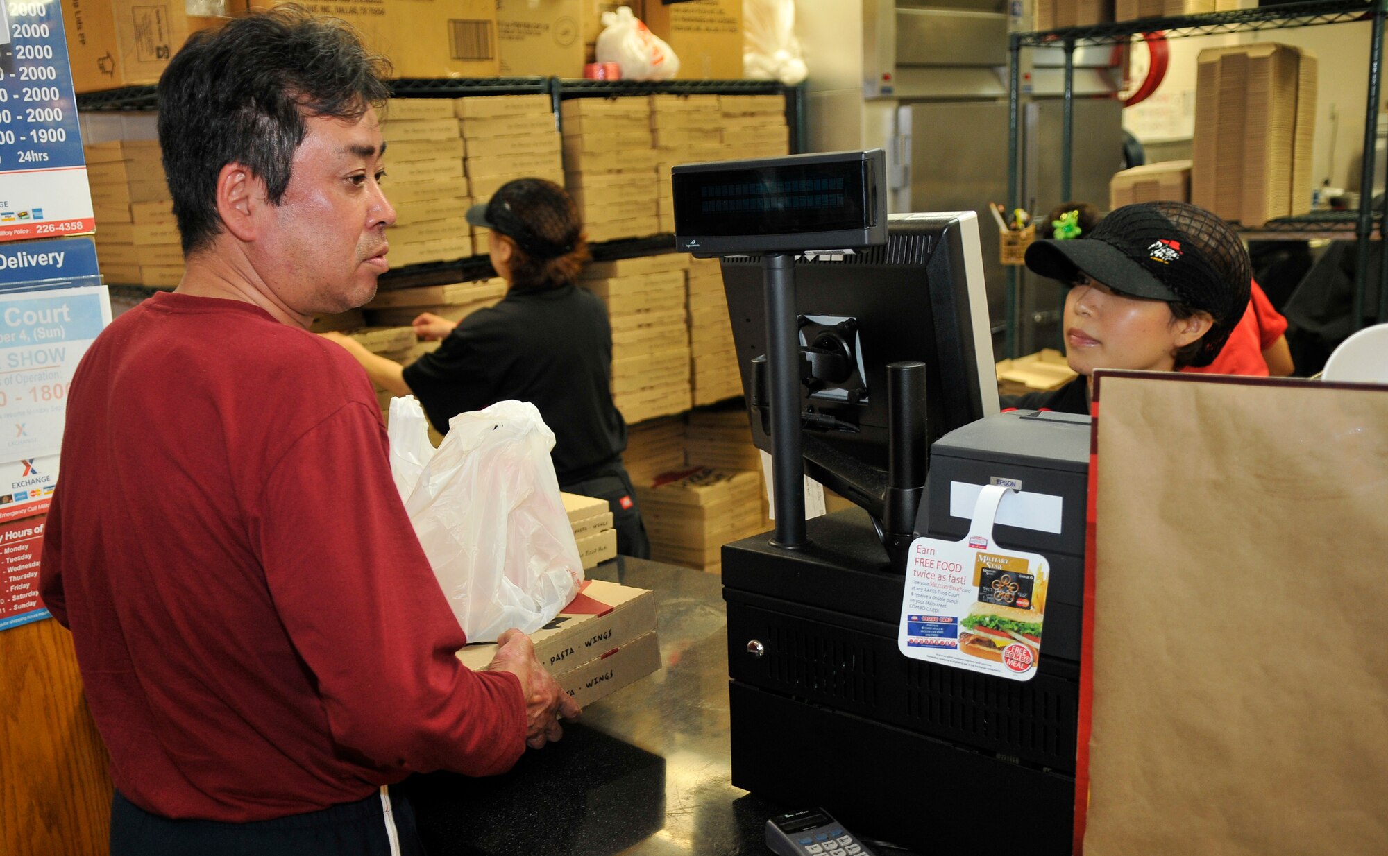 MISAWA AIR BASE, Japan—A customer receives pizzas from a vendor that prepared more than 1,200 pizzas in preparation for Misawa’s 32nd annual air fest here Sept.4. The Japan Air Self-Defense Force and the 35th Fighter Wing, with associated tenant units, hosted more than 100,000 visitors at the  air fest, which was an opportunity for visitors to see eight aerial demonstrations with 19 static displays of JASDF, U.S. Air Force, U.S. Navy aircraft and private operators. Air Fest 2011 also marked the last flight of Miss Veedol, a single engine aircraft that in 1931 flew non-stop across the Pacific Ocean from Sabishiro Beach, Misawa, Japan to Wenatchee, Washington, U.S. (U.S. Air Force photo/Tech. Sgt. Phillip Butterfield)  