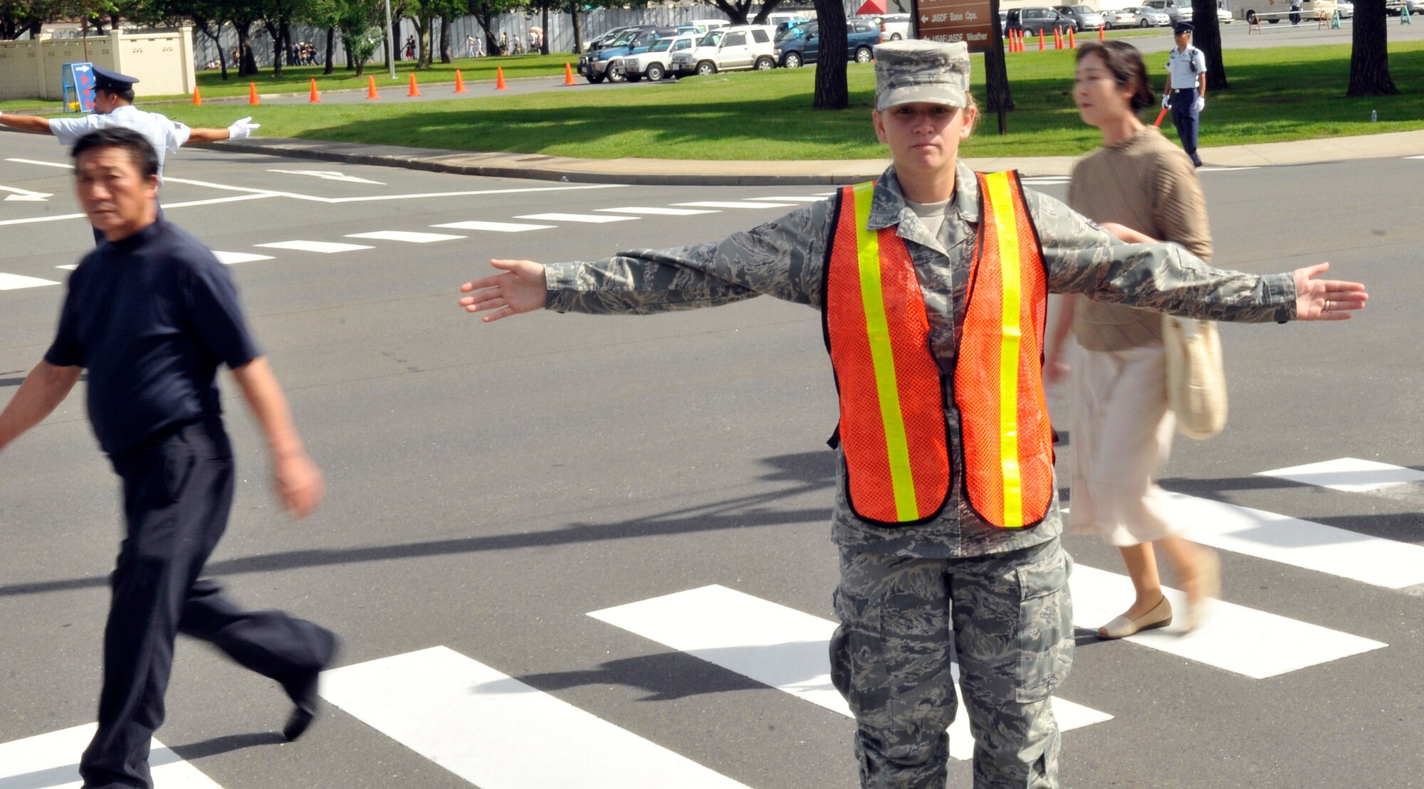 MISAWA AIR BASE, Japan – Airman 1st Class Brittany White, 35th Communications Squadron communications security clerk, directs traffic Sept. 4. The 35th Security Forces Squadron used approximately 90 augmentees to assist in traffic control. The Japan Air Self-Defense Force and the 35th Fighter Wing, with associated tenant units, hosted more than 100,000 visitors at Misawa's annual air fest Sept. 4. Air Fest 2011 was an opportunity for visitors to see eight aerial demonstrations with 19 static displays of JASDF, U.S. Air Force, U.S. Navy aircraft and private operators. Air Fest 2011 also marked the last flight of Miss Veedol, a single engine aircraft that in 1931 flew non-stop across the Pacific Ocean from Sabishiro Beach, Misawa, Japan to Wenatchee, Washington, U.S. (U.S. Air Force photo/Tech. Sgt. Phillip Butterfield)  