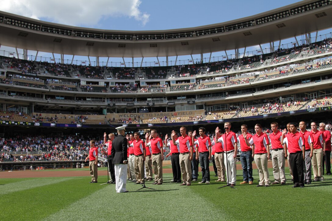 Maj. Kenneth C. Gawronski, the Commanding Officer of Recruiting Station Twin Cities, recites the Oath of Enlistment with the 2011 Twins Platoon, during a pregame ceremony in commemoration of the original 1967 Twins Platoon at Target Field, Sept. 5. Twenty four local young men and women were sworn into the U.S. Marine Corps as the "Twins Platoon" in commemoration of the group of 150 who swore in on June 28, 1967.