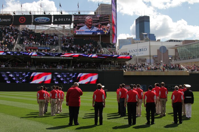 Paul Schroeder performs the Honorary Flag Raising as thousands of fans and the two Twins Platoons watch, during a pregame ceremony in commemoration of the original 1967 Twins Platoon at Target Field, Sept. 5. Twenty four local young men and women were sworn into the U.S. Marine Corps as the "Twins Platoon" in commemoration of the group of 150 who swore in on June 28, 1967.