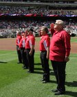 Six members of the original 1967 Twins Platoon salute to the playing of the National Anthem during a pregame ceremony where 24 local young men and women were sworn in to the U.S. Marine Corps, at Target Field, Sept. 5.