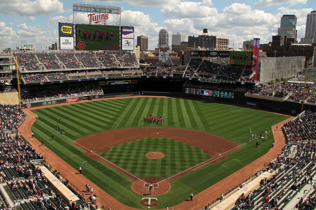 Twenty-four young men and women march into the center of Target Field during a pre-game ceremony Sept. 5 in commemoration of the 1967 Twins Platoon. These twenty-two men and two women, who are from the local area, took the oath of enlistment and were sworn into the Marine Corps in commemoration of the group of 150 warriors who swore in on June 28, 1967. This 2011 Twins Platoon shipped off to boot camp the next day to start their journey toward becoming a U.S. Marine. For additional imagery from the event, visit www.facebook.com/rstwincities.