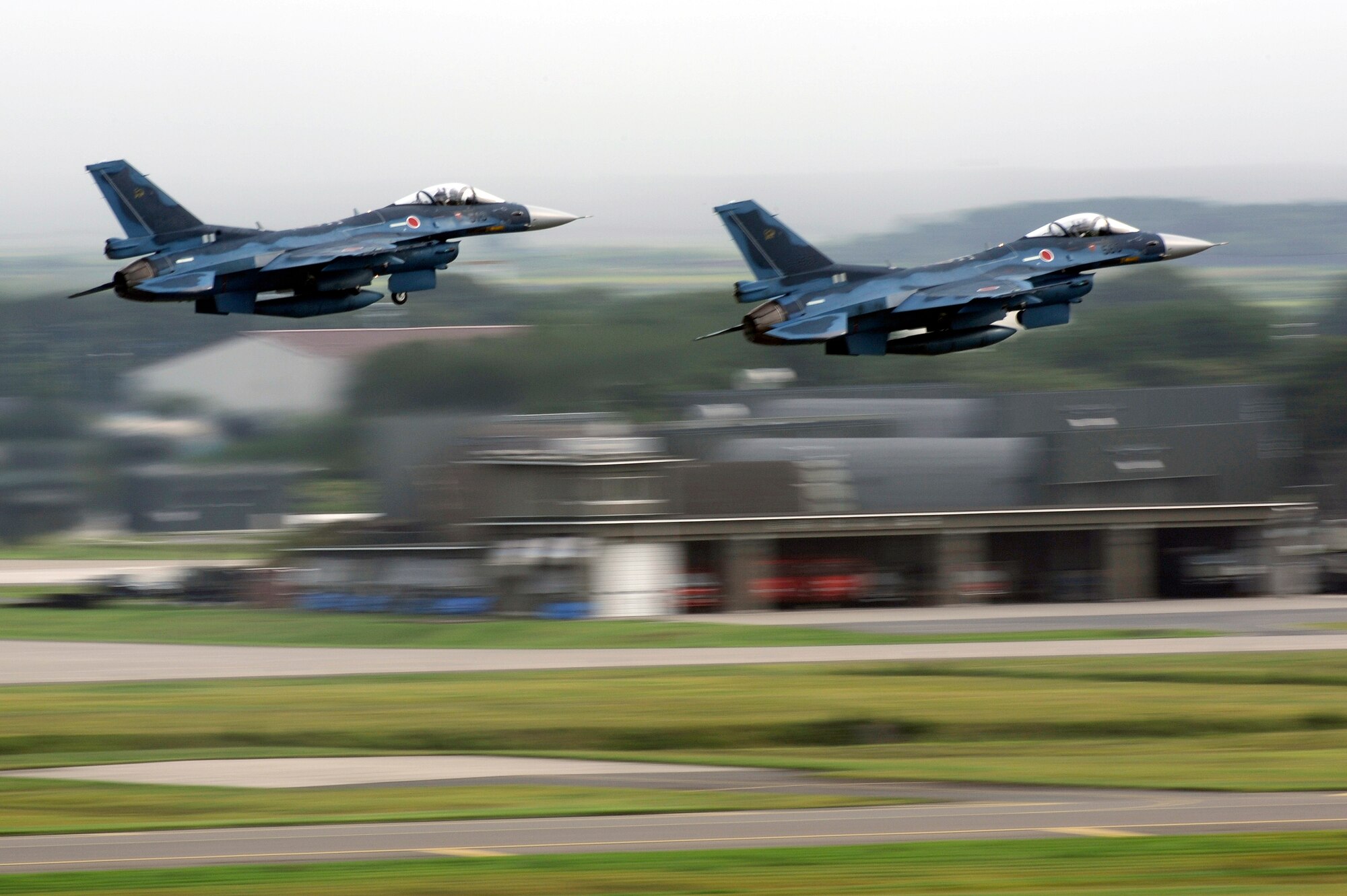 MISAWA AIR BASE, Japan -  Two Japan Air Self-Defense Force (JASDF) F-2 aircraft take-off during Misawa's 32nd annual air fest Sept. 4. Air Fest 2011 was an opportunity for approximately 100,000 attendees to see eight aerial demonstrations with 19 static displays of JASDF, U.S. Air Force, U.S. Navy aircraft and private operators. Air Fest 2011 also marked the last flight of Miss Veedol, a single engine aircraft that in 1931 flew non-stop across the Pacific Ocean from Sabishiro Beach, Misawa, Japan to Wenatchee, Washington, U.S. (U.S. Air Force photo/Tech. Sgt. Marie Brown)