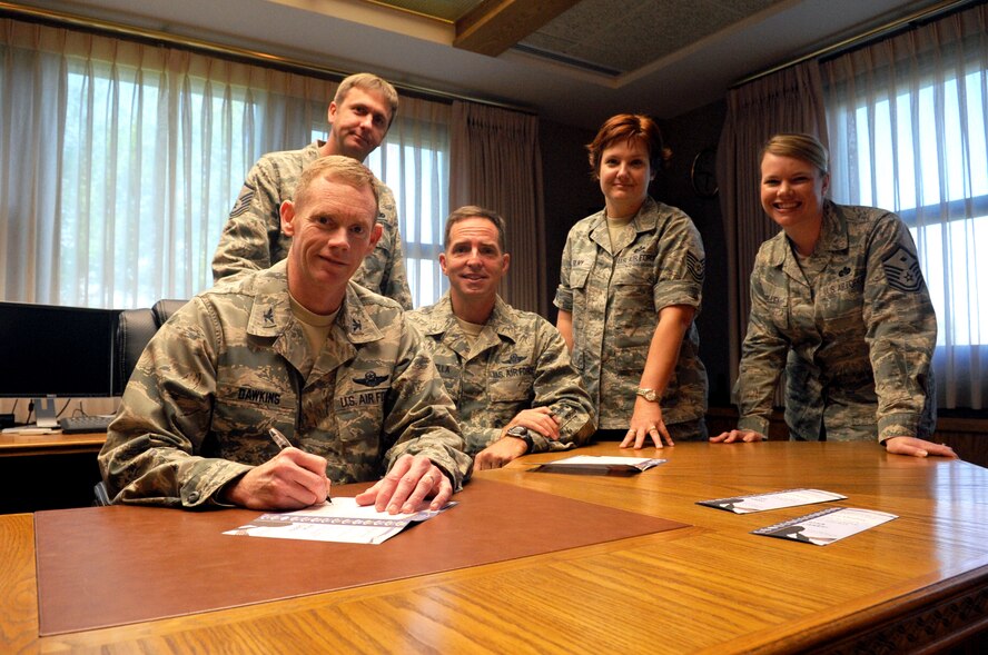 MINOT AIR FORCE BASE, N.D. -- Col. James Dawkins, 5th Bomb Wing commander, recently became a member of the Minot Air Force Sergeant’s Association Chapter 959. Chief Master Sgt. Kevin Jurgella, 5th BW command chief, transferred his AFSA membership to the Magic City. Members of AFSA have continually dedicated their service in speaking on behalf of service members, advocating for improved quality of life and economic fairness that support the well-being of Air Force enlisted members and their families. For information on becoming a member of AFSA, contact Master Sgt. Michael Shelley, chapter President, at 784-5459. (U.S. Air Force Photo/Senior Airman Jesse Lopez)
