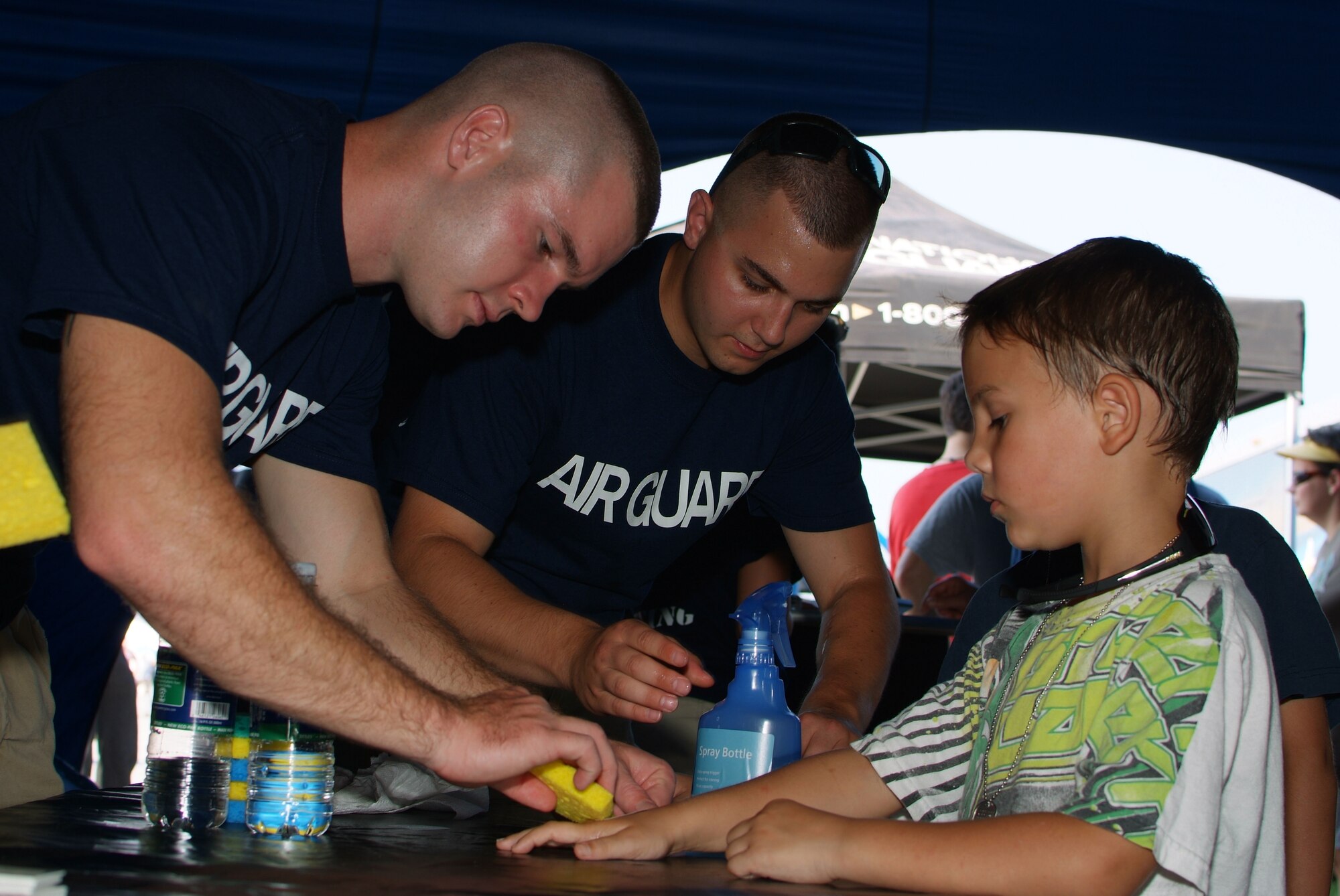 Recruiters from the 179th Airlift Wing and 200th REDHORSE Squadron build the Air Guard display tent at the Cleveland Air Show in Cleveland, OH, September 2, 2011. All branches of the U.S. Military were present as well as recruiters representing each at the event taking place at Burke Airport on the shores of Lake Erie. ( U.S. Air Force Photo by Staff Sgt. Robert J. Koehler)( Released)
