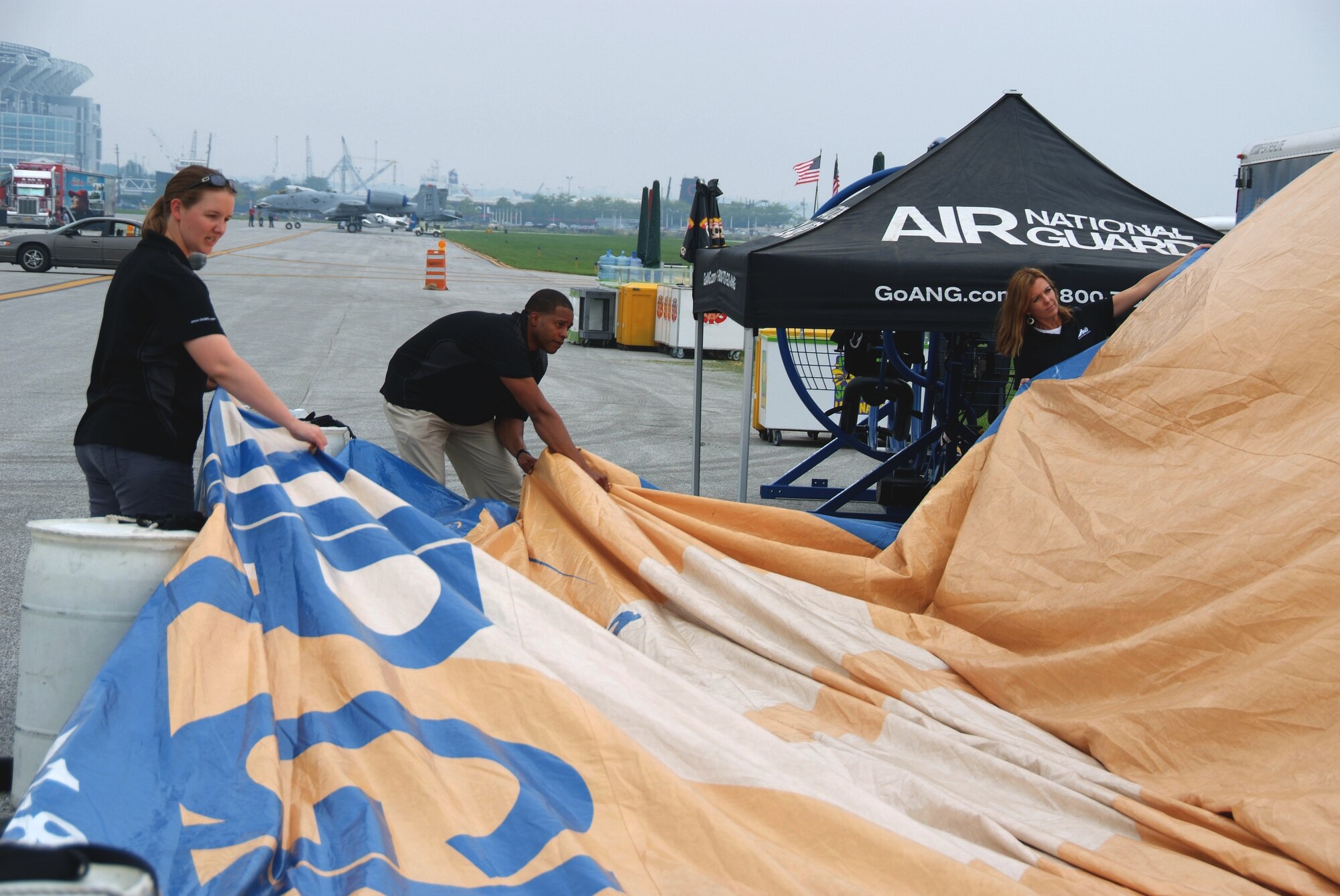 Recruiters from the 179th Airlift Wing and 200th REDHORSE Squadron build the Air Guard display tent at the Cleveland Air Show in Cleveland, OH, September 2, 2011. All branches of the U.S. Military were present as well as recruiters representing each at the event taking place at Burke Airport on the shores of Lake Erie. ( U.S. Air Force Photo by Staff Sgt. Robert J. Koehler)( Released)