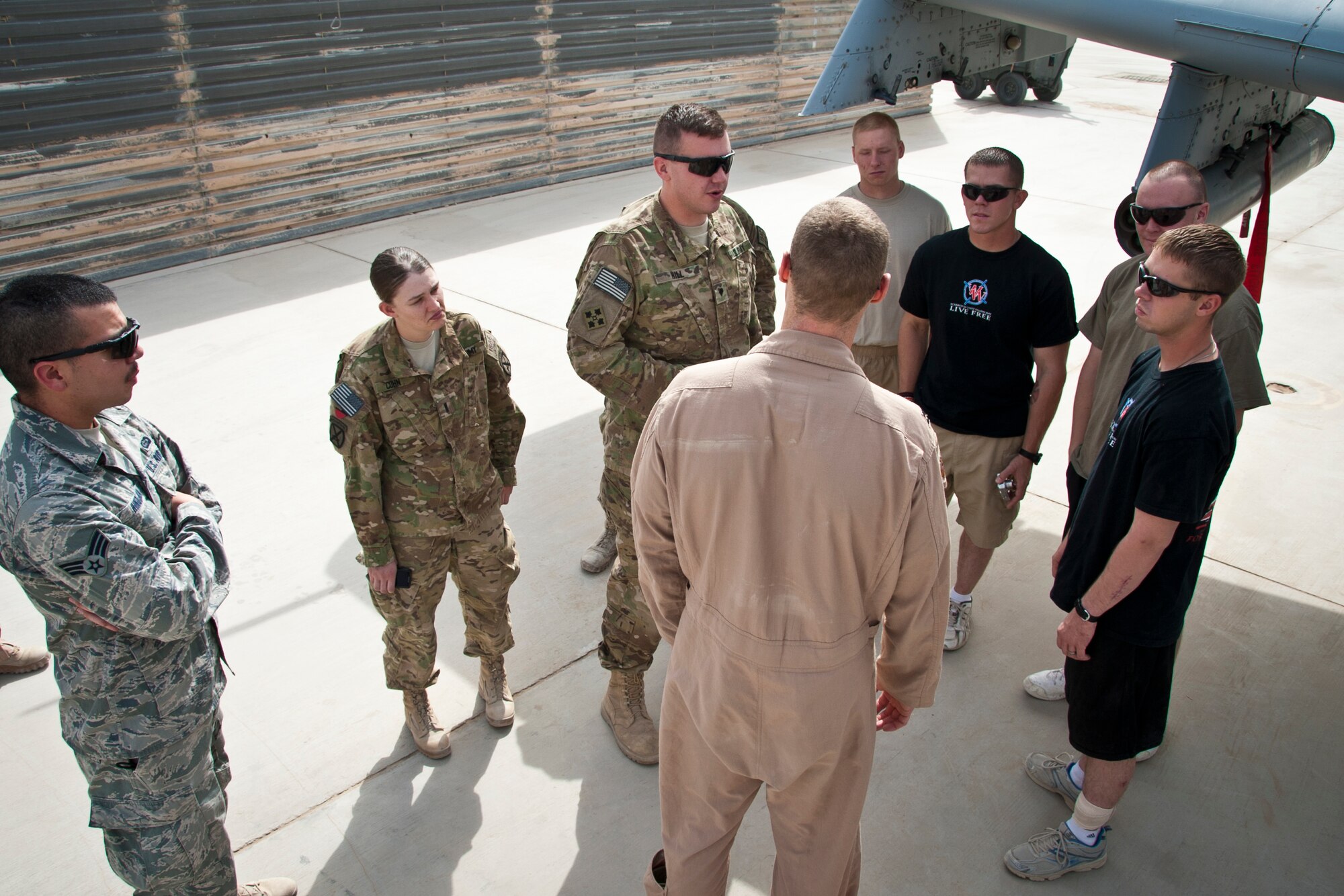 KANDAHAR AIRFIELD, Afghanistan -- Air Force Capt. Chris Palmer, 74th Expeditionary Fighter Squadron pilot, speaks to several wounded warriors about the A-10 Thunderbolt II during a tour Aug. 29, 2011. The wounded warriors are currently being treated at Kandahar's Role 3 for various injuries to include traumatic brain injury, shrapnel wounds and strained limbs. (U.S. Air Force photo by Senior Airman David Carbajal) (U.S. Air Force photo by Senior Airman David Carbajal)