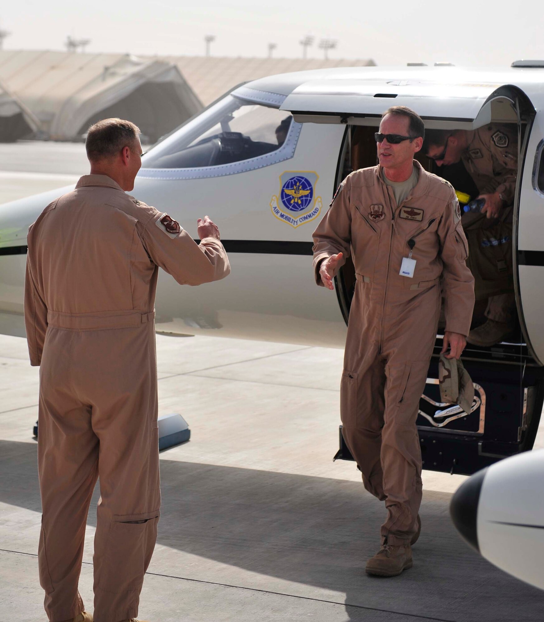 Brig. Gen. Jeff Lofgren, the 380th Air Expeditionary Wing commander, greets Maj. Gen. James J. Jones as he arrives at the 380th AEW in Southwest Asia for a visit Sep. 2, 2011. Jones is the deputy commander of U.S. Air Forces Central Command and the Combined Force Air Component deputy commander for U.S. Central Command. He visited the base to meet with deployed service members and to learn more about how they support overseas contingency operations. (U.S. Air Force photo/Tech Sgt. Patrick Mitchell)