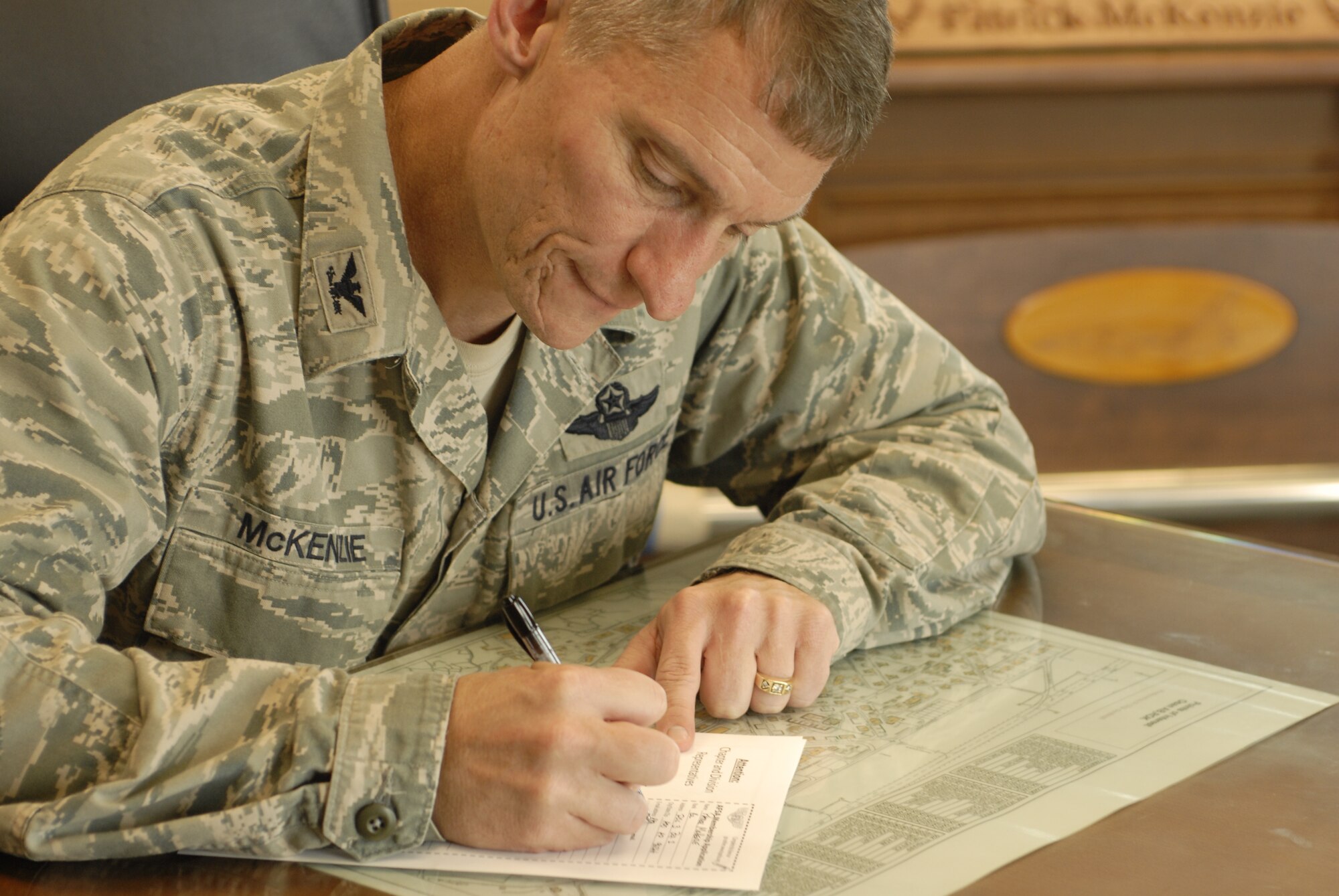 Col. Patrick McKenzie signs an Air Force Sergeant’s Association membership card Aug. 24, 2011 at Osan Air Base, Republic of Korea showing his support for AFSA. AFSA represents the total Air Force enlisted corps’ men and women and their families. Air Force active duty, Air National Guard and Reserve command members are the dynamic components of AFSA’s membership. AFSA represents each military professional. Join 120,000 fellow Airmen today; its voice is only as strong as its membership. (U.S. Air Force photo/Staff Sgt. Gena Armstrong)