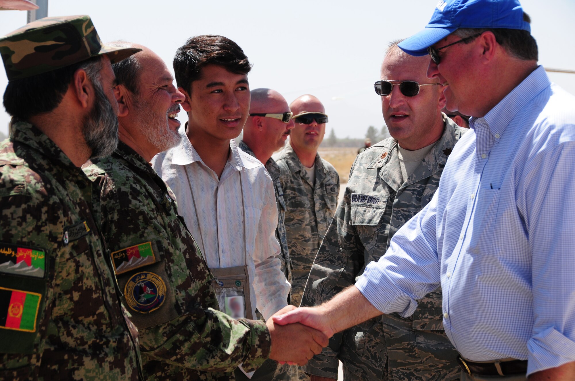 Secretary of the Air Force Michael Donley shakes hands with an Afghan Air Force airman at Shindand Air Base, Shindand, Afghanistan, September 5, 2011. Donley was in Afghanistan to meet with U.S. Airmen and officials there. (U.S. Air Force photo by Senior Airman Amber Williams)