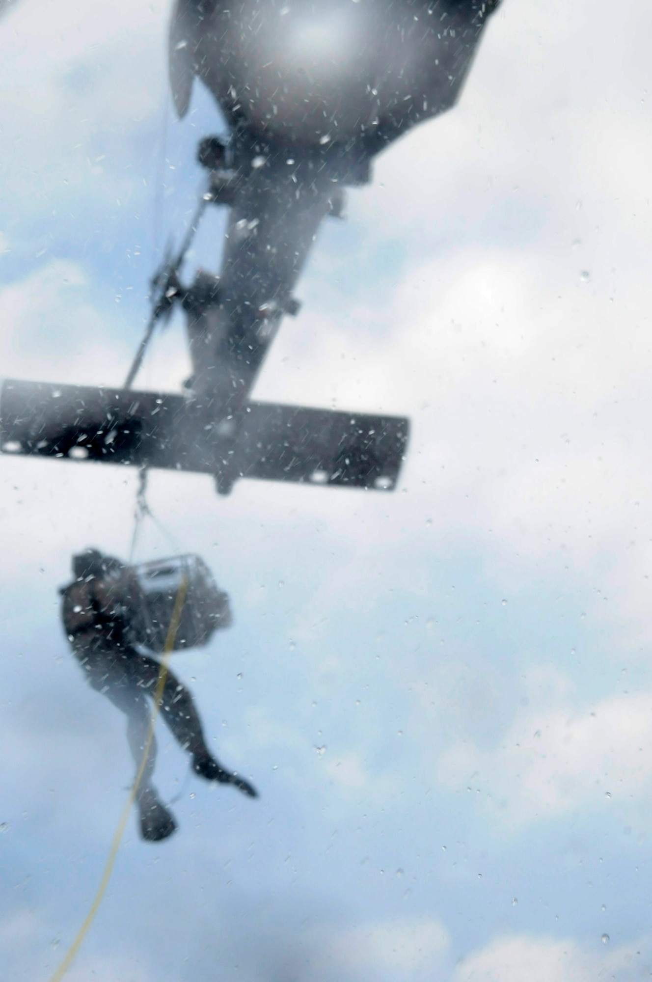 Pararescuemen with the 31st Rescue Squadron conduct training over rough seas off an HH-60 Pave Hawk from the 33rd Rescue Squadron at White Beach, Japan, Sept. 1. The Kadena Air Base members can be called upon at a moment's notice and must train and work together to prepare for support in combat rescue and disaster relief. (U.S. Air Force Photo/Tech. Sgt. Jocelyn Rich)