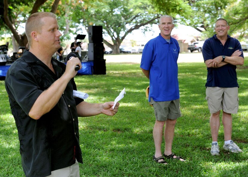 Master Sgt. Mark Hargis, manager theater supply operations (A4R), and Mahalo Bash coordinator kicks off this year’s festivities with the help of Pacific Air Forces Command Chief Master Sergeant Brooke McLean, and General Gary North, Pacific Air Forces commander, at Joint Base Pearl Harbor-Hickam, Sept. 1.  Mahalo Bash is an annual event hosted by the Pacific Air Forces commander to thank Airmen and their families for their service and hard work throughout the year. (U.S. Air Force photo/Tech. Sgt. Jerome S. Tayborn (Released))