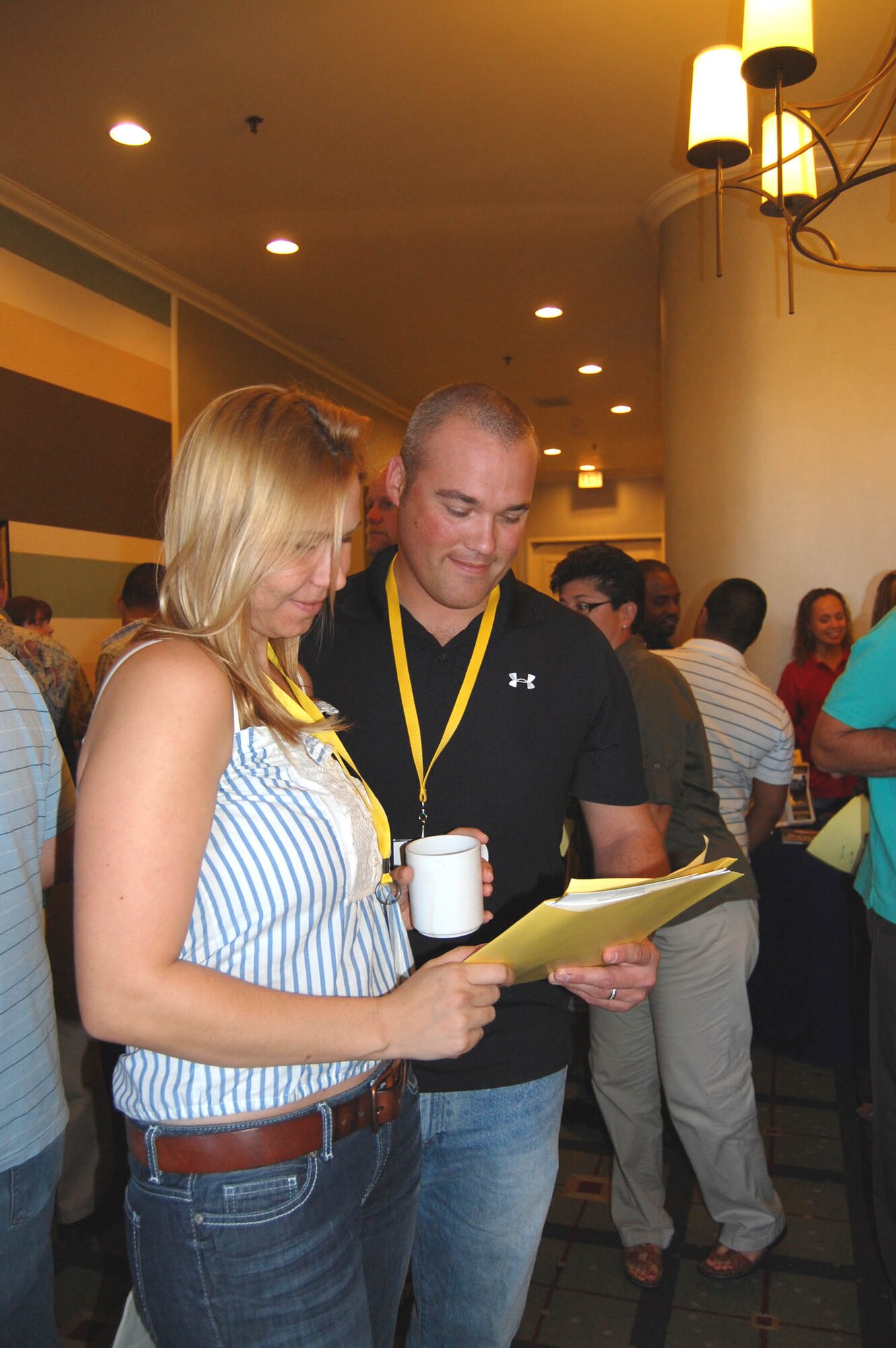 (Right) Tech. Sgt. Bryce Kelsey, 926th Aircraft Maintenance Squadron, and his wife review materials collected at the Yellow Ribbon conference in San Diego, Calif., on Aug. 27.