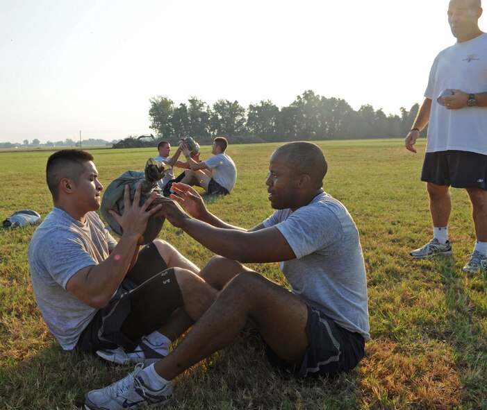 Members of the 2nd Security Forces Squadron at Barksdale Air Force Base, La., exchange sandbags Sept. 1 during tryouts for the 2 SFS Global Strike Challenge team. The Airmen trying out for the team endure rigorous tests to evaluate their fitness, land navigation skills and marksmanship. (U.S. Air Force photo/2nd Lt. Tori Lalich)(RELEASED)