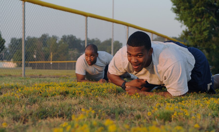 Staff sergeants Derek Rucker and Eric Murphy, 2nd Security Forces Squadron, high crawl through a field during tryouts for the 2 SFS Global Strike Challenge team at Barksdale Air Force Base, La., Sept. 1. Seven Barksdale Airmen will be on the 2 SFS team which will compete for the Charlie Fire Team Trophy during their portion of the challenge in November. (U.S. Air Force photo/2nd Lt. Tori Lalich)(RELEASED)