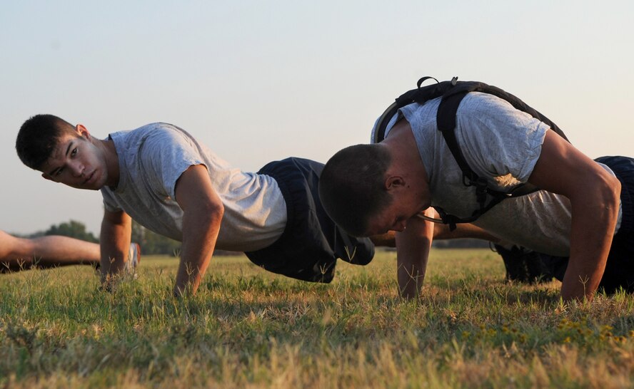 Airman 1st Class Andrew Beyer, 2nd Security Forces Squadron, looks on as his battle-buddy completes push-ups during tryouts for the 2 SFS Global Strike Challenge team at Barksdale Air Force Base, La., Sept. 1. Seven Barksdale Airmen will be on the 2 SFS team which will compete for the Charlie Fire Team Trophy during their portion of the challenge in November. (U.S. Air Force photo/2nd Lt. Tori Lalich)(RELEASED)