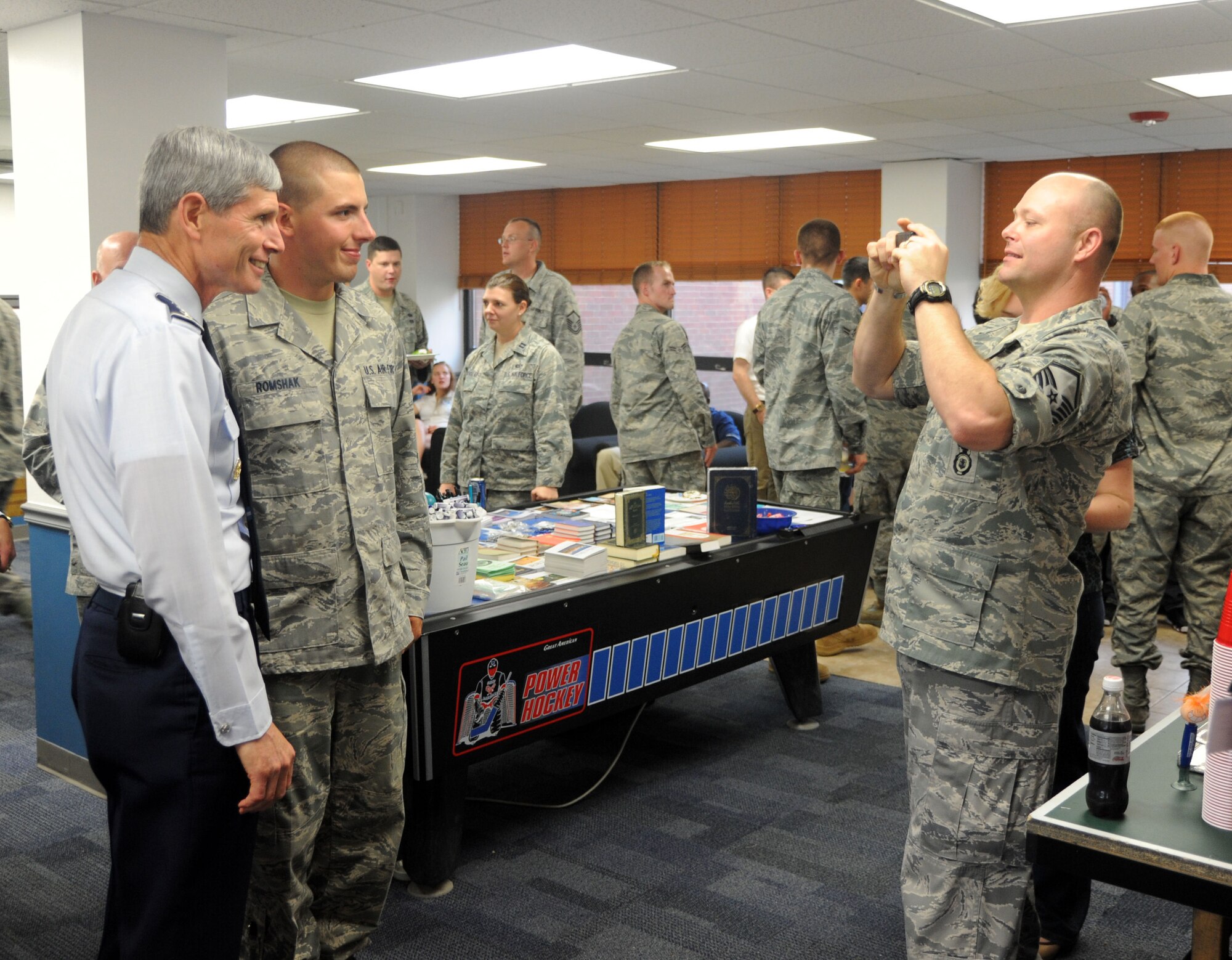 Master Sgt. Russel Ware takes a photo of Air Force Chief of Staff Gen. Norton Schwartz and Airman 1st Class Benjamin Romshak during a dorm dinner Aug. 31 at the 70th Intelligence, Surveillance and Reconnaissance Wing, located at Fort George G. Meade, Md. (U.S. Air Force photo/Staff Sgt. Dillon White)