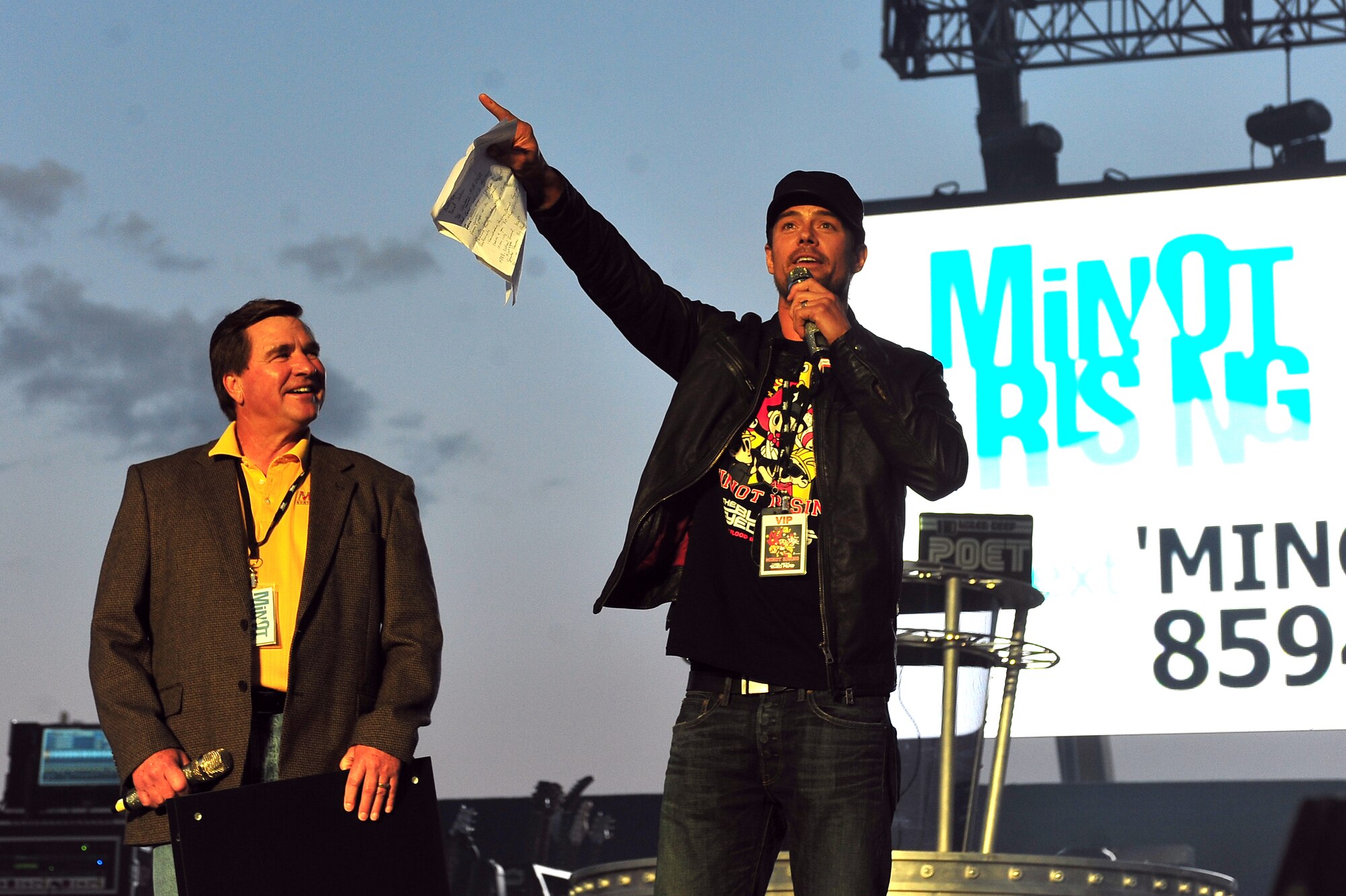 MINOT, N.D. -- Minot Mayor Curt Zimbelman alongside Josh Duhamel, actor and Minot native, speak to nearly 16,000 people in attendance for The Black Eyed Peas concert at the North Dakota State Fairgrounds, as part of an event orchestrated to support the flood relief, here Sept. 3. More than 200 Minot AFB Airmen volunteered to set up the electrifying evening, as a night of celebrity-filled fun comforted many Minot residents and Airmen who are still recovering from the tragic flood’s aftermath that displaced one-fourth of the city. All concert proceeds will go to the Minot Area Community Foundation’s Minot Area Recovery Fund to assist victims in Minot and surrounding flood affected communities. (U.S. Air Force Photo/Senior Airman Jesse Lopez)