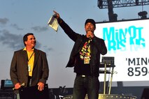 MINOT, N.D. -- Minot Mayor Curt Zimbelman alongside Josh Duhamel, actor and Minot native, speak to nearly 16,000 people in attendance for The Black Eyed Peas concert at the North Dakota State Fairgrounds, as part of an event orchestrated to support the flood relief, here Sept. 3. More than 200 Minot AFB Airmen volunteered to set up the electrifying evening, as a night of celebrity-filled fun comforted many Minot residents and Airmen who are still recovering from the tragic flood’s aftermath that displaced one-fourth of the city. All concert proceeds will go to the Minot Area Community Foundation’s Minot Area Recovery Fund to assist victims in Minot and surrounding flood affected communities. (U.S. Air Force Photo/Senior Airman Jesse Lopez)