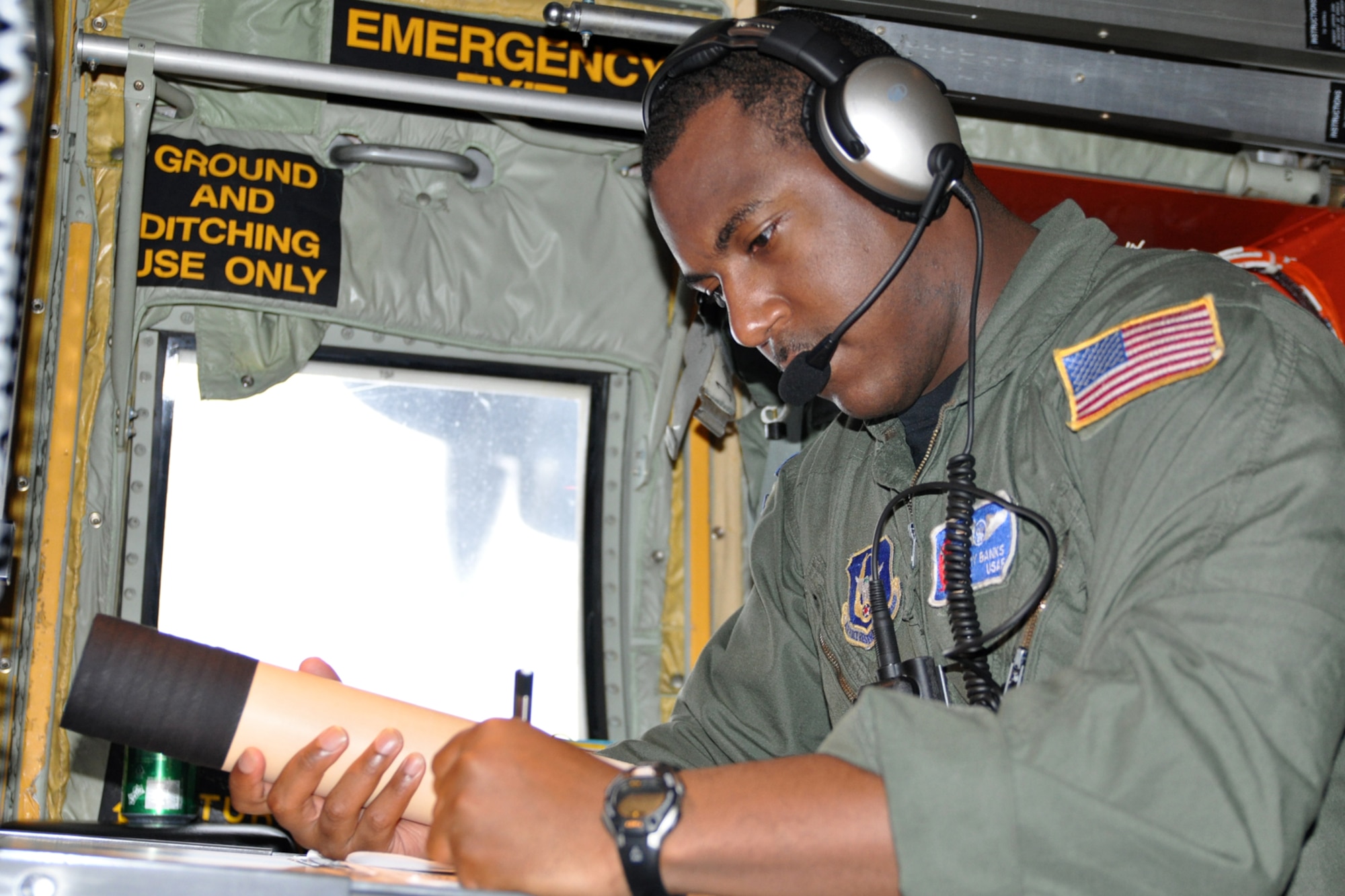 Staff Sgt. Larry Banks, a weather reconnaissance loadmaster with the 53rd Weather Reconnaissance Squadron, prepares to drop a parachute-borne sensor, known as a dropsonde Sept. 2. Banks collects and records vertical meteorlogical data from the dropsonde to measure and encode weather data down to the ocean surface. (U.S. Air Force photo by Staff Sgt. Valerie Smock)