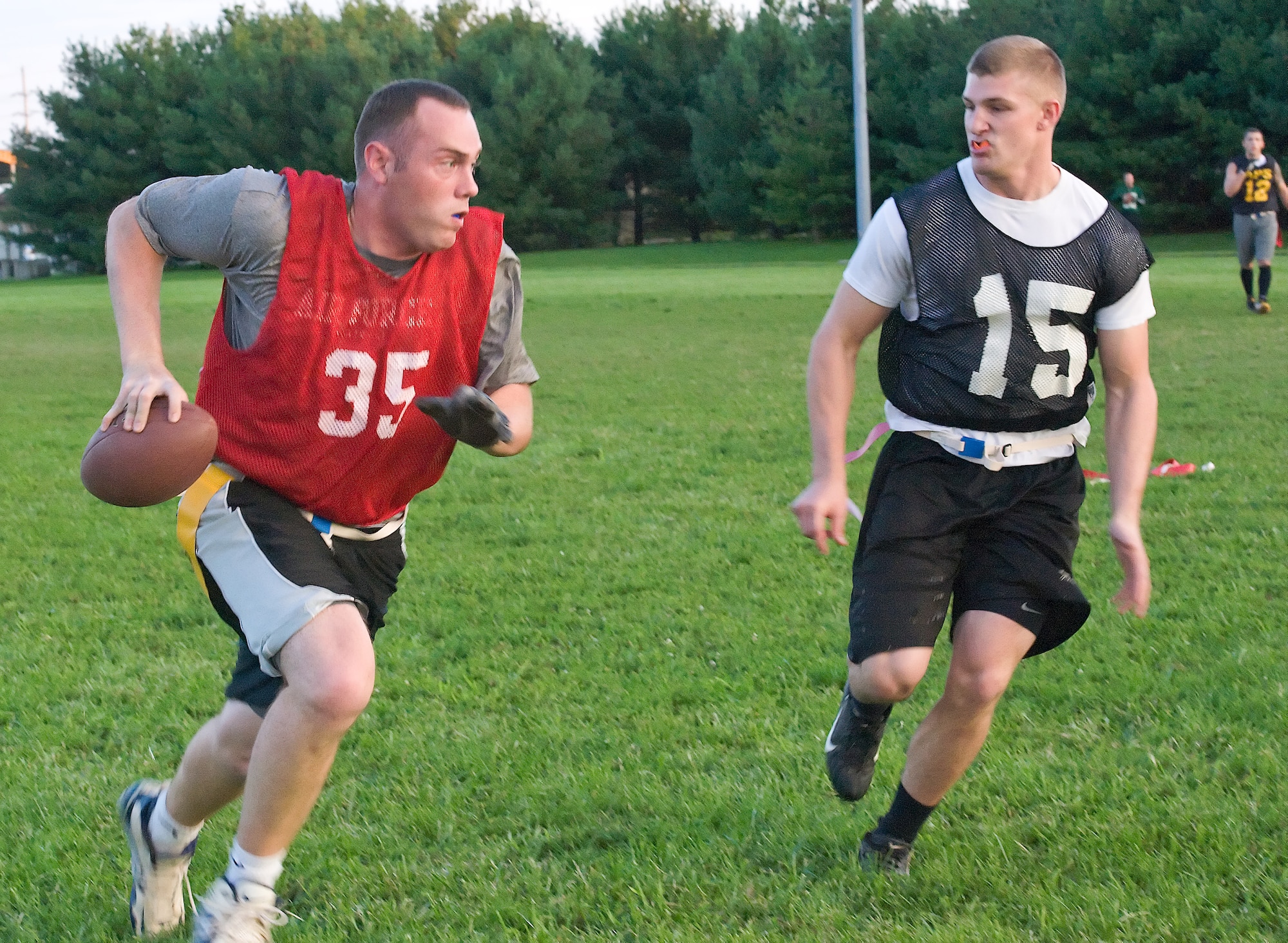 Michael Wagner runs to evade Raymond Bennett Sept. 1, 2011, at Dover Air Force Base, Del. The 436th Aerial Port Squadron defeated the 436th Communications Squadron 21 – 8. (U.S. Air Force photo by Airman 1st Class Samuel Taylor)