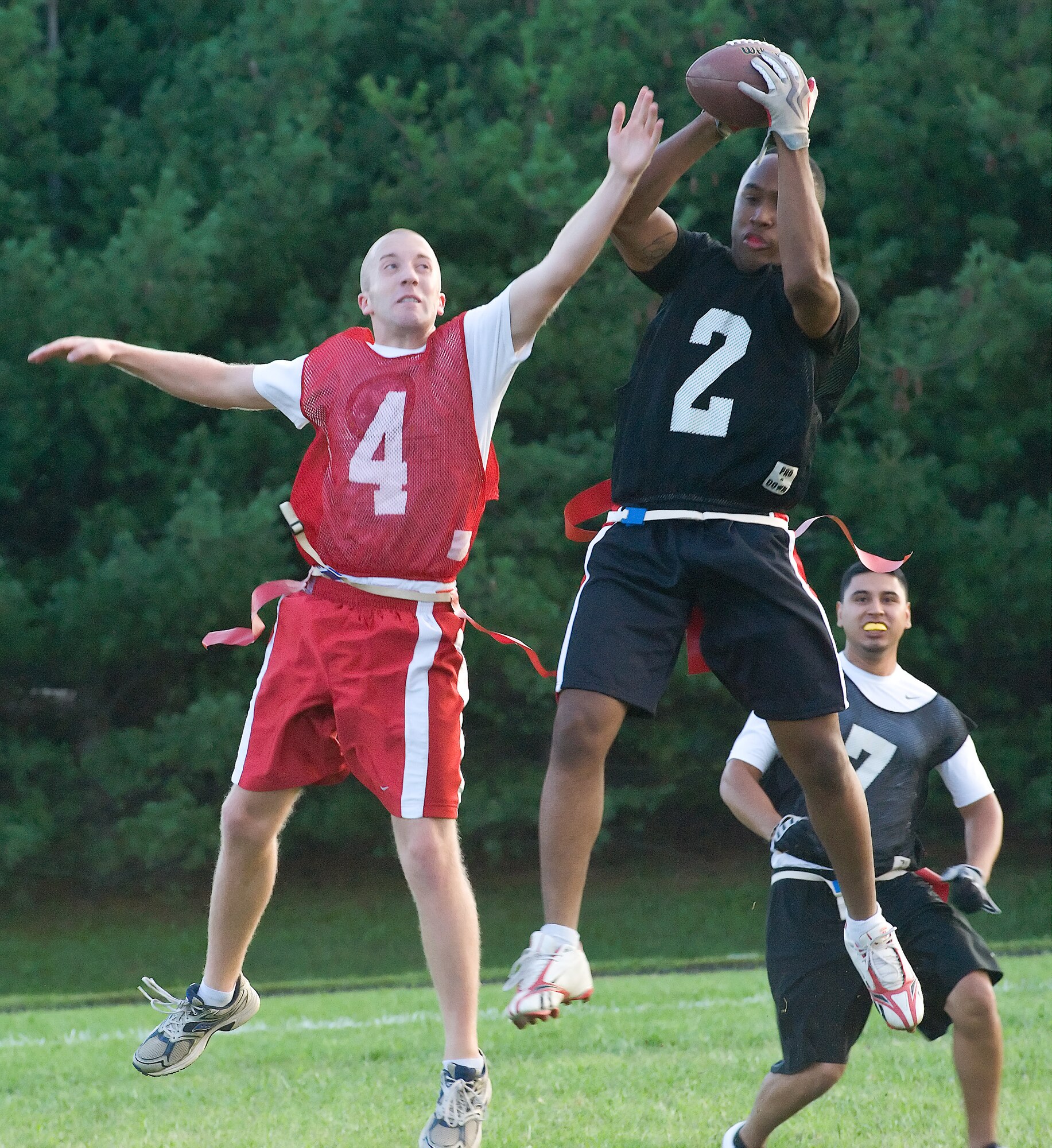 Brian Burns (left) tries to swat a pass away from Cordiares Brewer Sept. 1, 2011, at Dover Air Force Base, Del. The 436th Aerial Port Squadron defeated the 436th Communications Squadron 21 – 8. (U.S. Air Force photo by Airman 1st Class Samuel Taylor)