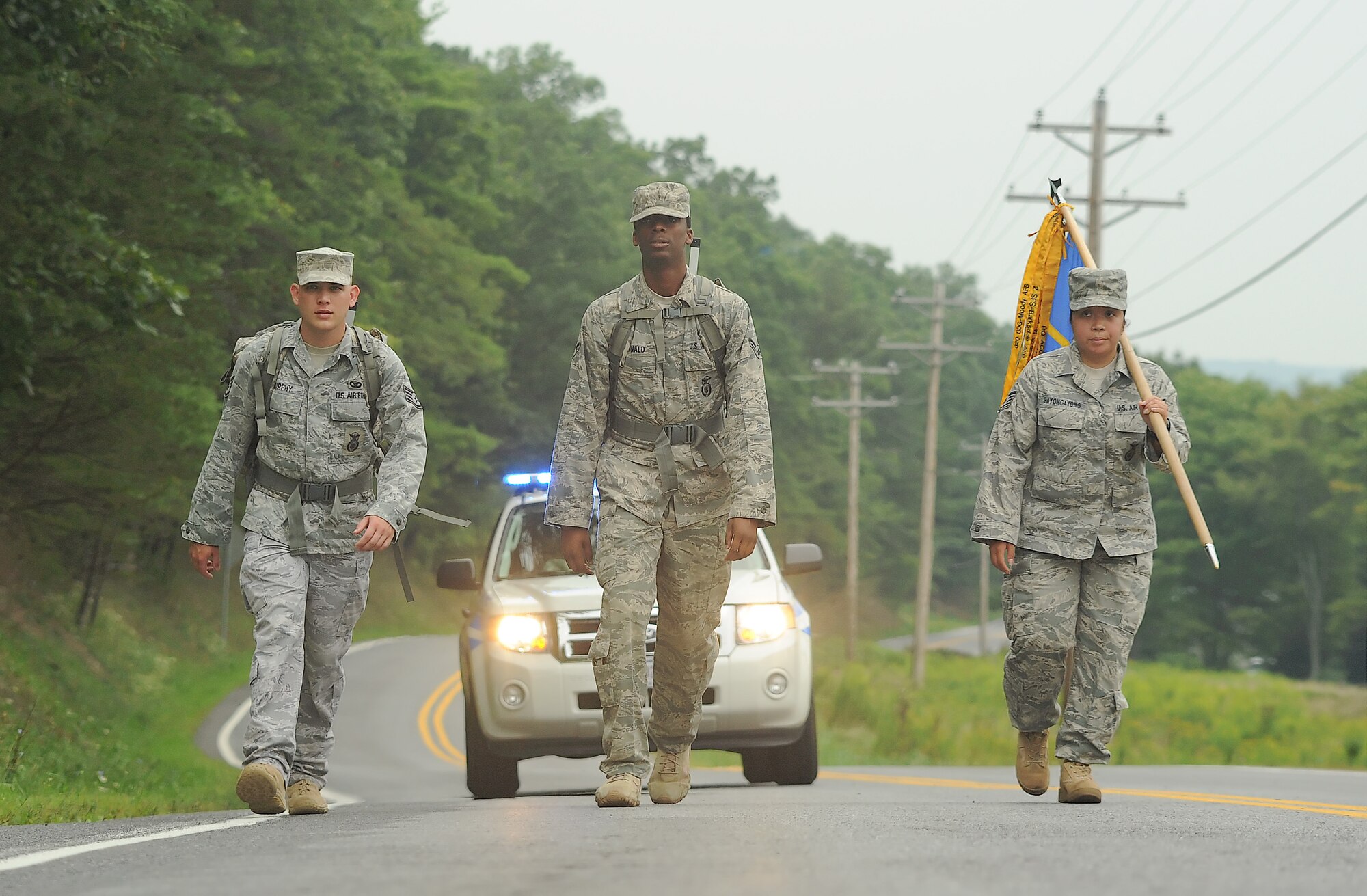 Staff Sgt. Jerry Murphy (left), Airman 1st Class Moses McDonald and Tech. Sgt. Ninanona Payongayong, all with the 436th Security Forces Squadron, march Sept. 1, 2011, outside of Wells Tannery, Pa.  A 151 mile march throughout Pennsylvania was Dover Air Force Base, Del.,’s part in the 9/11 Ruck March to Remember, which started in San Antonio and ends at Ground Zero in New York City on Sept. 11, 2011. (U.S. Air Force photo by Airman 1st Class Jacob Morgan)
