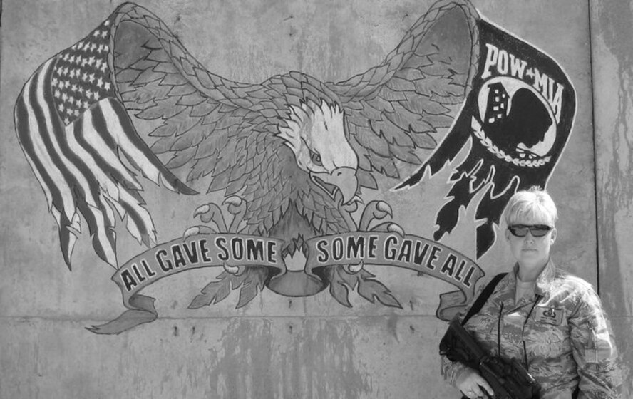 U.S. Air Force Master Sgt. Sonya Couture stands in front of a POW/MIA mural in Kabul, Afghanistan. Couture is deployed out of the 23rd Operations Support Squadron, Moody Air Force Base, Ga., and is currently on a one-year deployment with the 438th Air Expeditionary Wing where she trains and advises the Afghan air force. (contributed photo)