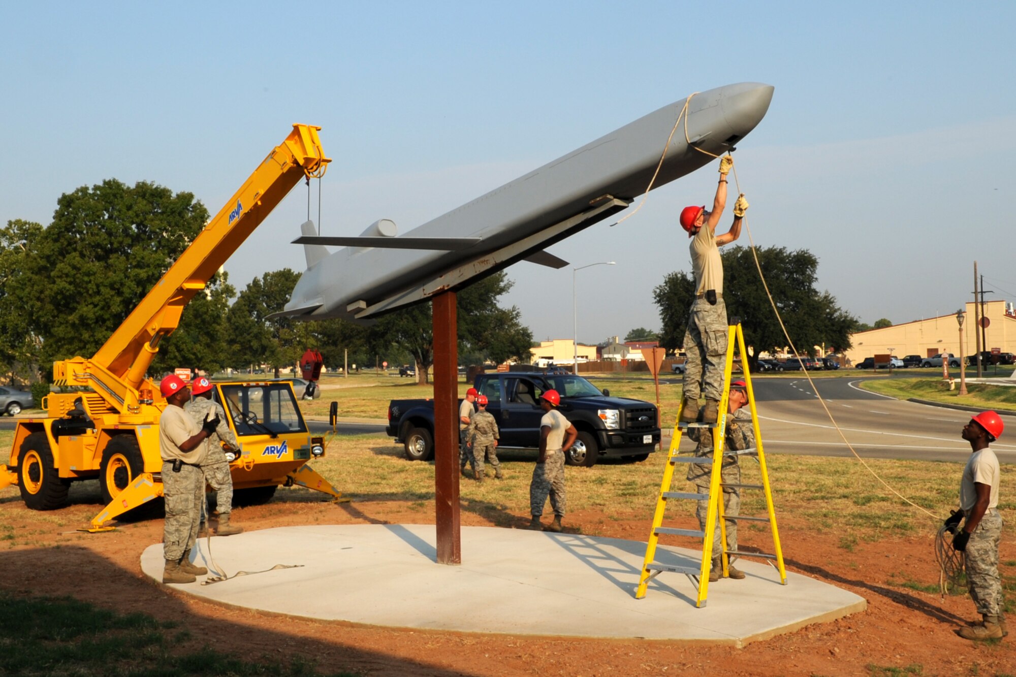 Personnel from the 307th Rapid Engineer Deployable Heavy Operational Repair Squadron Engineers (RED HORSE) wrap up equipment after mounting a Conventional Air Launched Cruise Missile (CALCM) replica onto its pedestal at Barksdale Air Force Base, La., Aug. 31, 2011. The CALCM is the center piece of a monument dedicated to the weapon system and is scheduled to be unveiled on Sept. 9, 2011. (U.S. Air Force photo by Master Sgt. Greg Steele/Released)