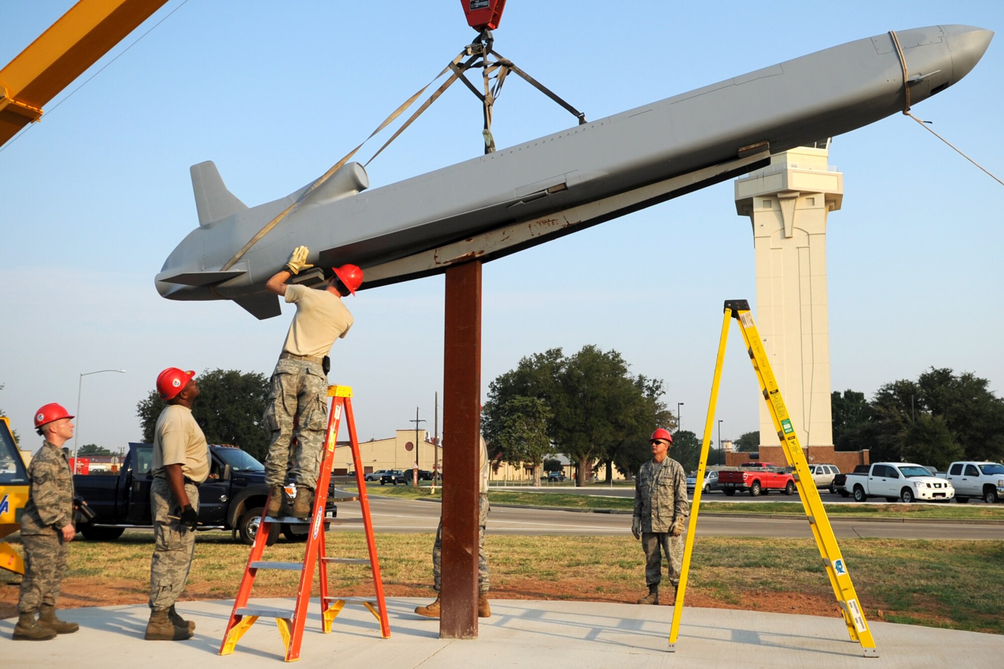 Personnel from the 307th Rapid Engineer Deployable Heavy Operational Repair Squadron Engineers (RED HORSE) mount a Conventional Air Launched Cruise Missile (CALCM) replica onto its pedestal at Barksdale Air Force Base, La., Aug. 31, 2011. The CALCM is the center piece of a monument dedicated to the weapon system and is scheduled to be unveiled on Sept. 9, 2011. (U.S. Air Force photo by Master Sgt. Greg Steele/Released)