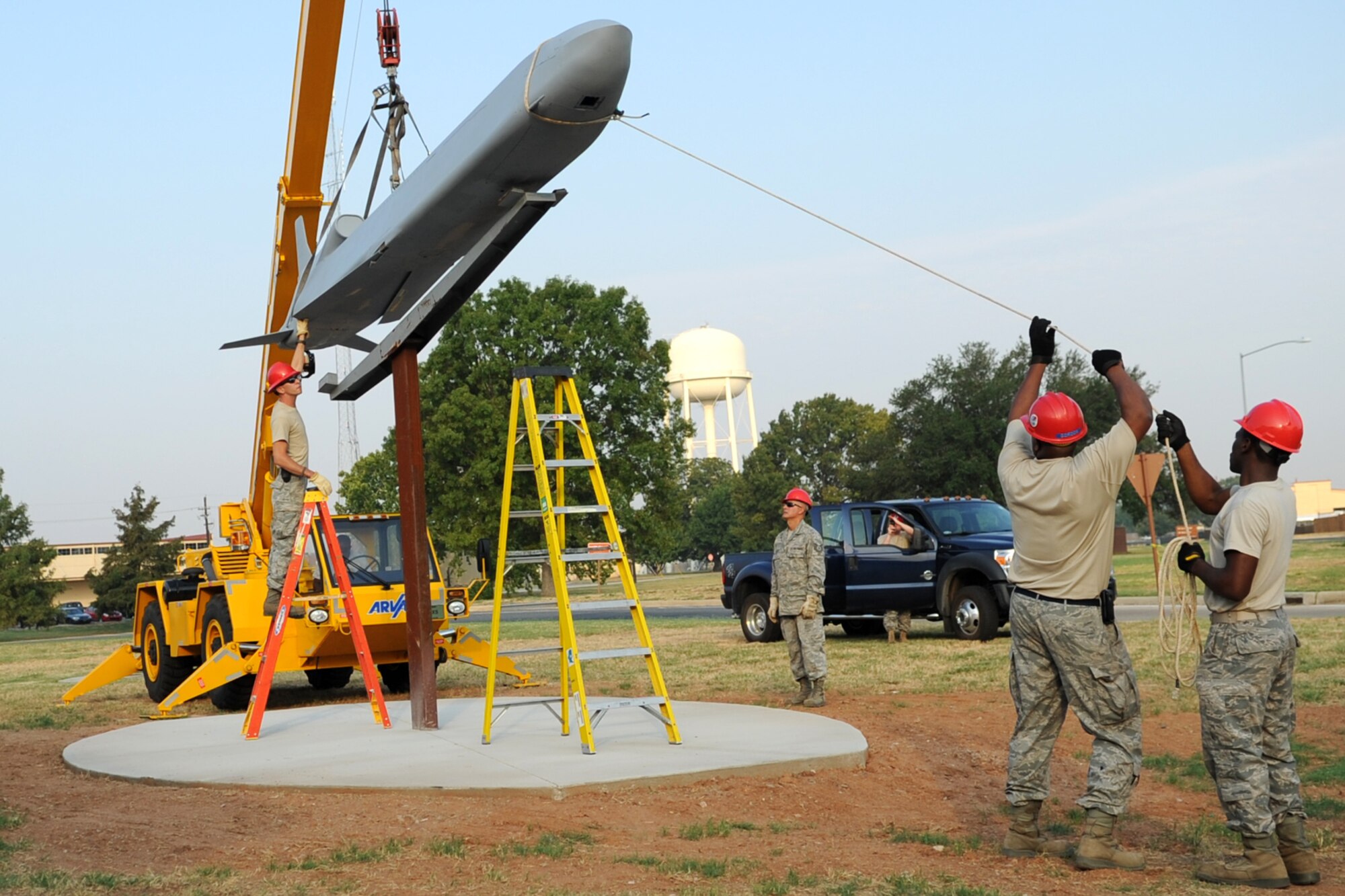 Personnel from the 307th Rapid Engineer Deployable Heavy Operational Repair Squadron Engineers guide a Conventional Air Launched Cruise Missile (CALCM) replica onto its pedestal at Barksdale Air Force Base, La., Aug. 31, 2011. The CALCM is the center piece of a monument dedicated to the weapon system and is scheduled to be unveiled on Sept. 9, 2011. (U.S. Air Force photo by Master Sgt. Greg Steele/Released)