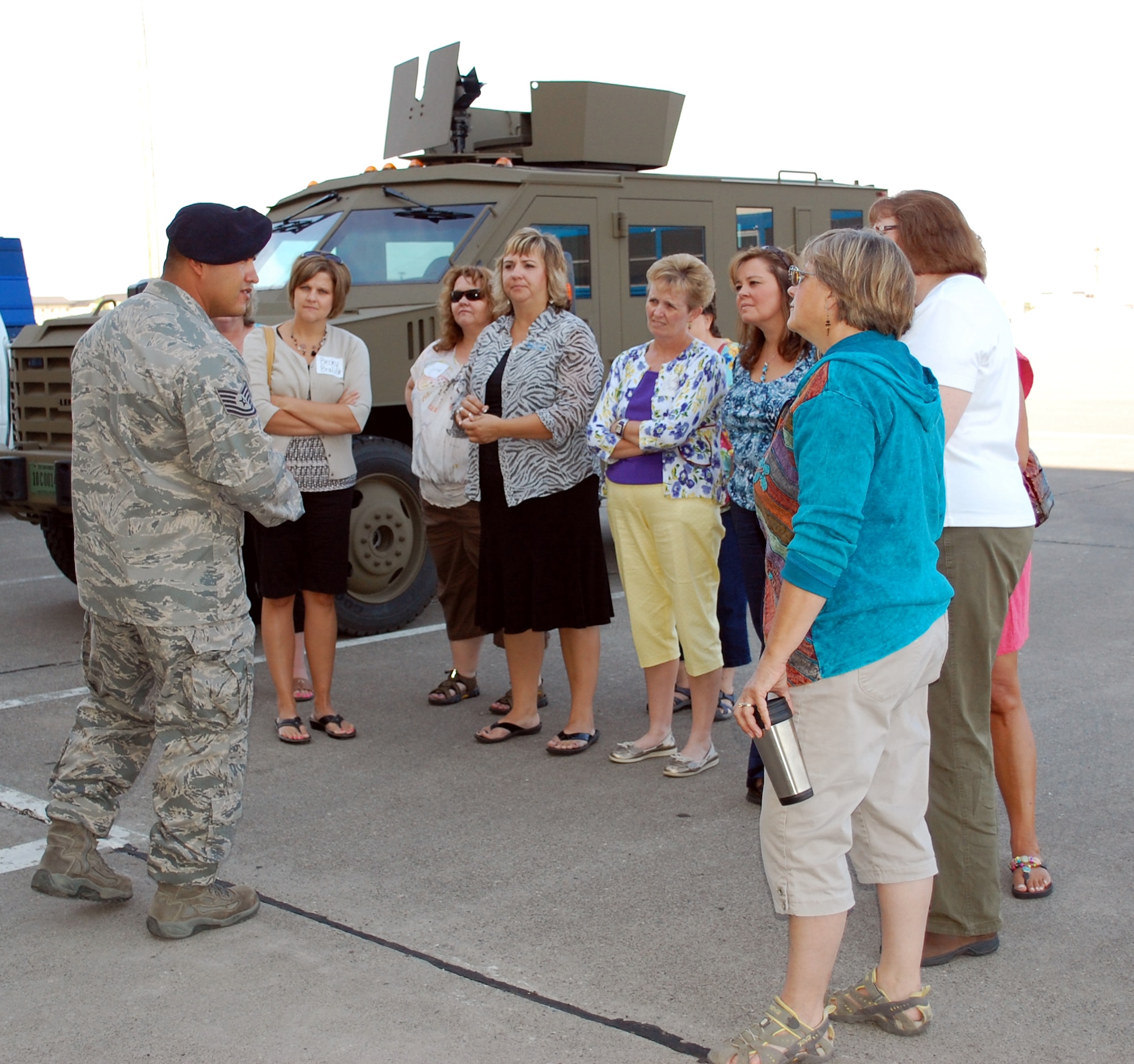 Tech. Sgt. Esequiel Munguia, an NCO with the Tacticel Response Force, explains to a group of Loy Elementary School teachers the duties and responsibilities of his unit before they give their guests a demonstration in their training "shoot house." Thirty members of the faculty came to Malmstrom for an orientation tour. (U.S. Air Force photo/Valerie Mullett)