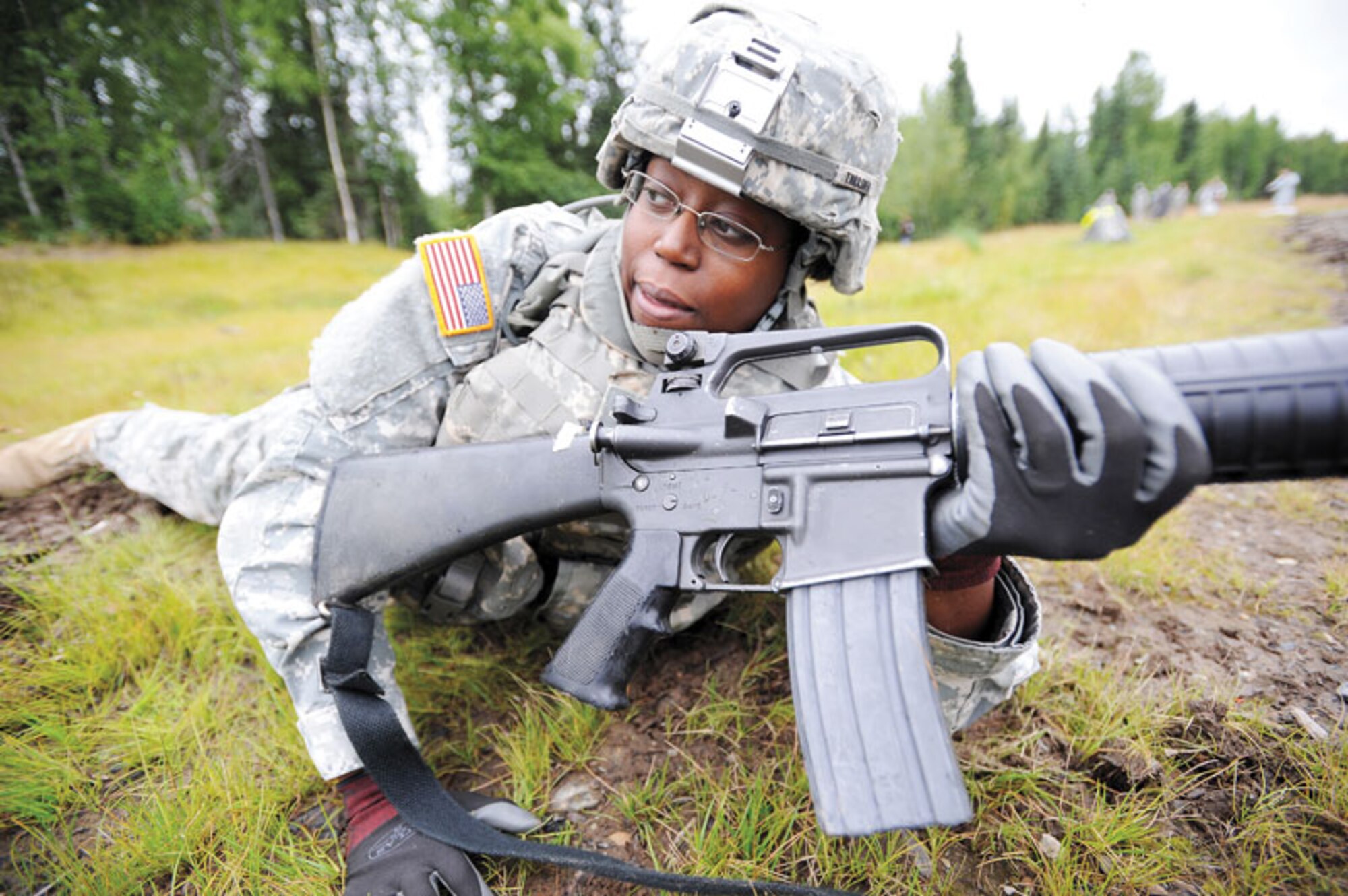 Spc. Leandria Thrasher pulls security and talks with squad mates during a react-to-contact drill Aug. 25. (U.S. Air Force photo/Justin Connaher)