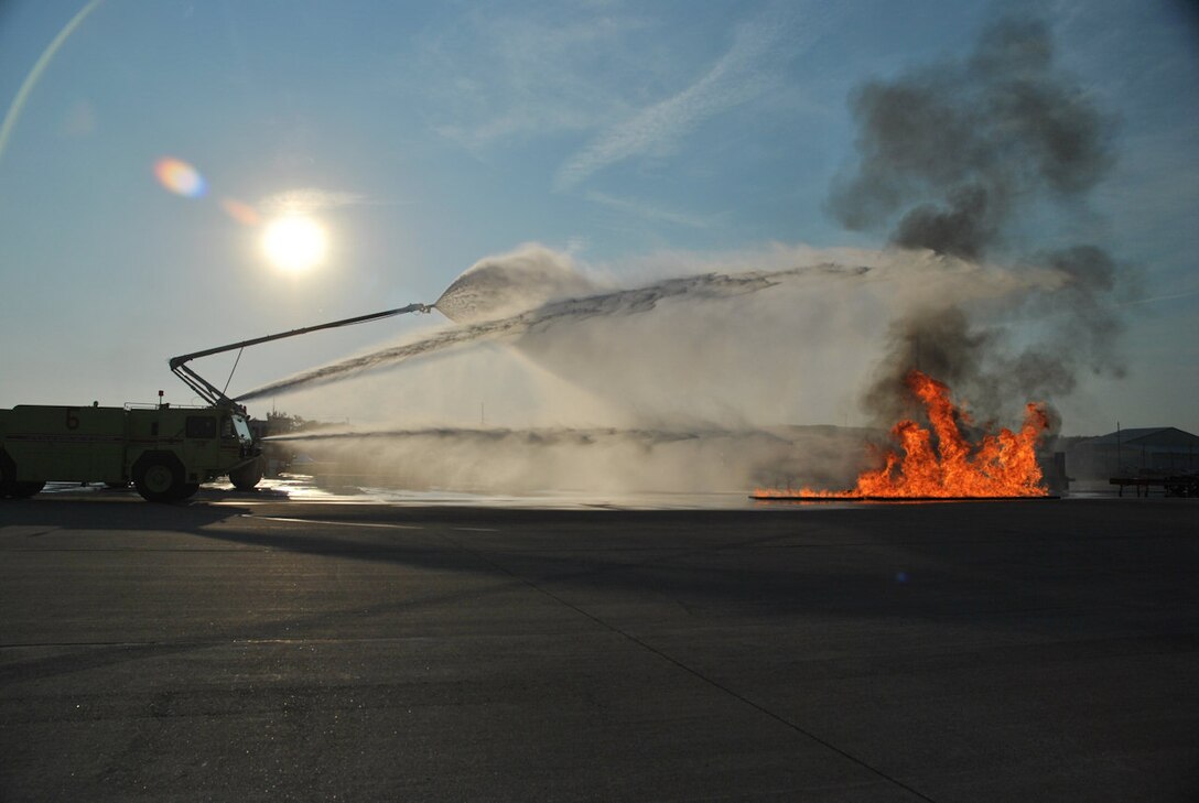 Firefighters from the Selfridge Air National Guard Base, Mich., fire department work to extinguish a fire during a training exercise on the base, Sept. 2, 2011. The firefighters worked on a variety of scenarios involving a fire in and around an aircraft simulator. (USAF photo by Dan Meinhard)