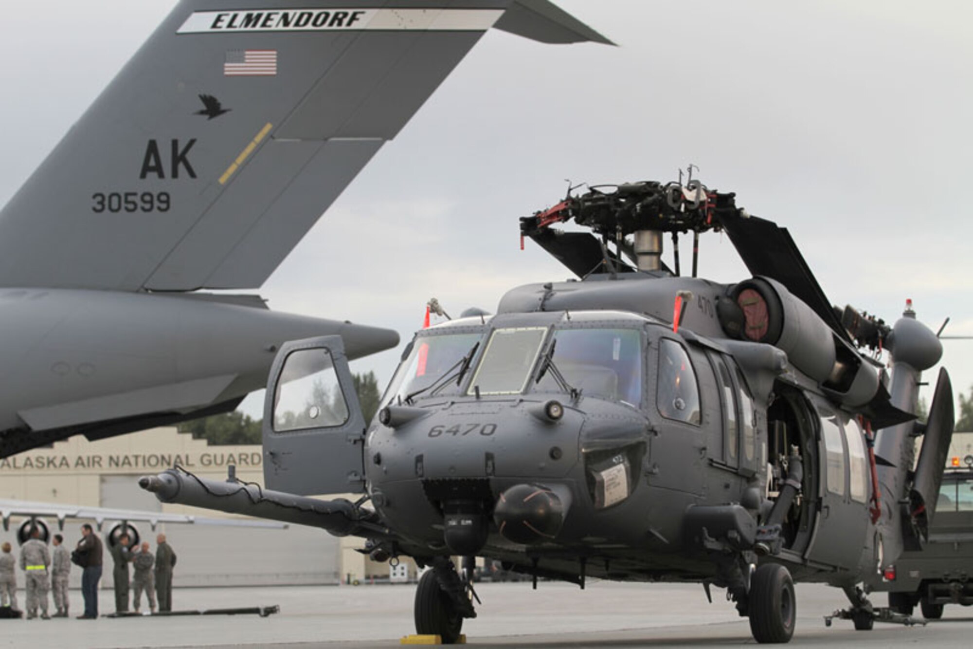 An Alaska Air National Guard 210th Rescue Squadron HH-60 Pave Hawk helicopter sits on the flight line at Joint Base Elmendorf-Richardson waiting to be loaded on a 517th Airlift Squadron C-17 Globemaster III. The Alaska National Guardsmen departed Alaska Saturday on their way to Charleston, W. Va., to assist search and rescue efforts in response to Hurricane Irene.   (U.S. Air Force photos/Maj. Guy Hayes)
