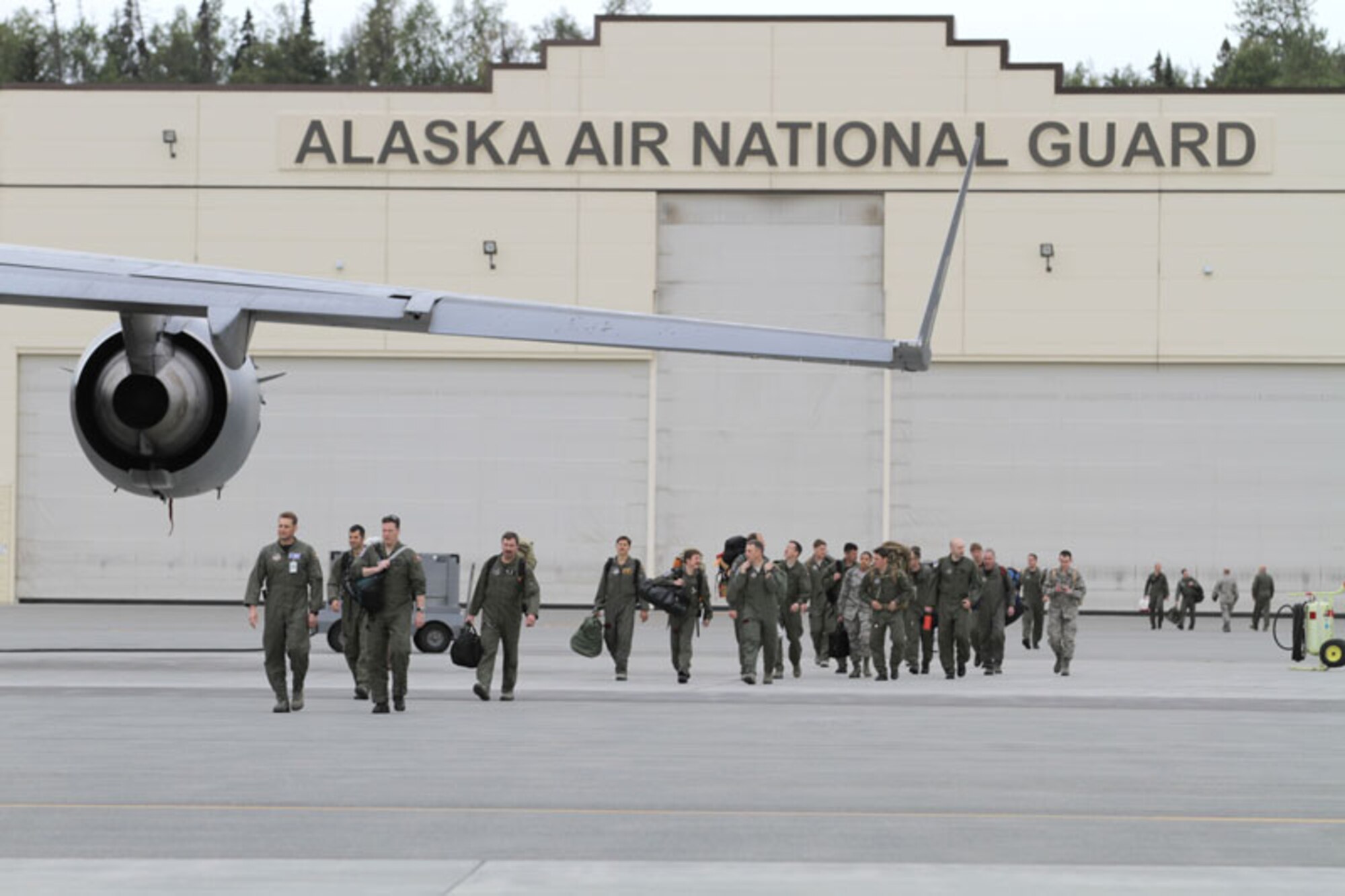 Alaska Air National Guardsmen walk across the flight line at Joint Base Elmendorf-Richardson before boarding a C-17. (U.S. Air Force photos/Maj. Guy Hayes)

