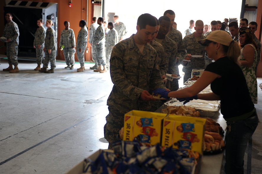 Volunteers from Veterans of Foreign Wars Post 9578 out of Nashville, Ga., serve food to Airmen from the 820th Base Defense Group at Moody Air Force Base, Ga., Sept 1, 2011. VFW Post 9578 donated and served food, drinks and desserts to the Airmen as a welcome home celebration. (U.S. Air Force photo by Senior Airman Ciara Wymbs/Released) 