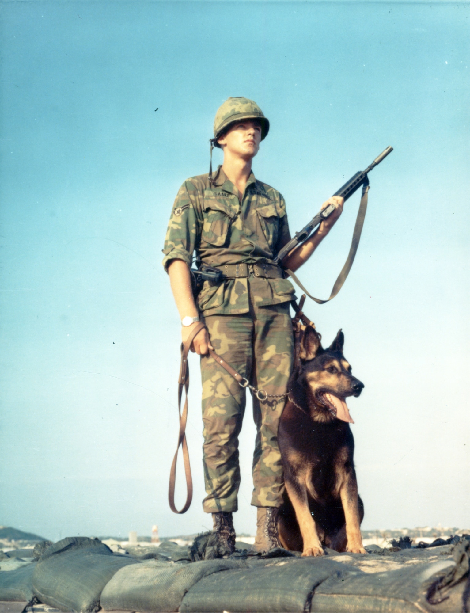 A1C David Shark with his sentry dog Heino at Cam Ranh Bay Air Base, South Vietnam.  It is not possible to overestimate the incredible bond that existed between handler and dog. The handler trusted the dog with his life, and the dog was absolutely loyal, even to the death. (U.S. Air Force photo).