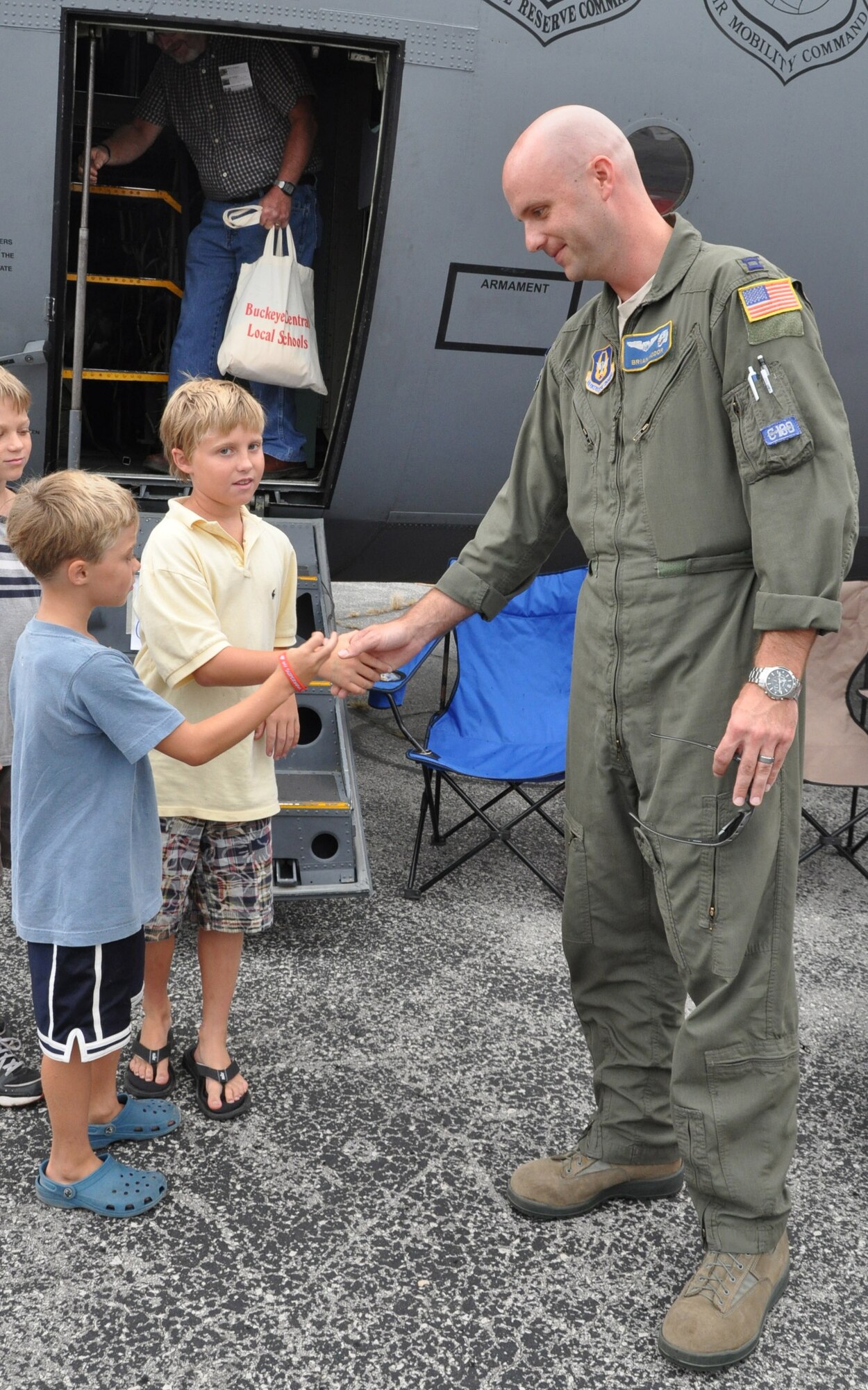CANFIELD, Ohio — Air Force Reserve Capt. Brian Hodor, a command pilot with the 910th Airlift Wing, shakes hands with children after they toured the C-130 Hercules at the Cleveland Airshow September 4. U.S. Air Force photo by Maj. Brent J. Davis