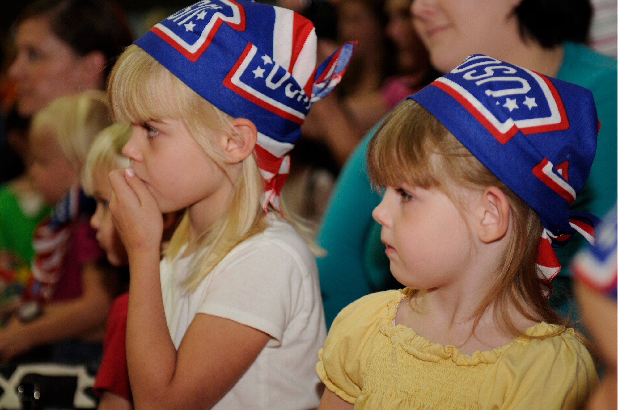 SPANGDAHLEM AIR BASE, Germany -- Sophie, left, and Hannah, daughters of Staff Sgt. Todd Dickson, 52nd Equipment Maintenance Squadron, watch Sesame Street perform here during the Sesame Street/USO Experience for Military Families tour Sept. 2 Skelton Memorial Fitness Center. Elmo and his Sesame Street pals perform at installations all around the world. The tour focuses on the challenges families face during deployments. (U.S. Air Force photo/Airman 1st Class Brittney Frees)