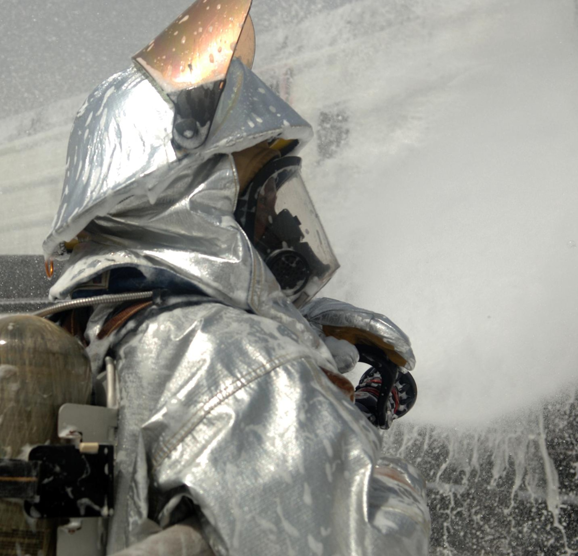 CAMP LEMONNIER, Djibouti -- Siyaad Cheik, Camp Lemonnier Fire Department firefighters sprays down a mock aircraft with AFFF foam concentrate during a training scenario, August 27. The Fire Department conducts routine training exercises to maintain skill proficiency. (U.S. Air Force photo by Senior Airman Jarad A. Denton) 