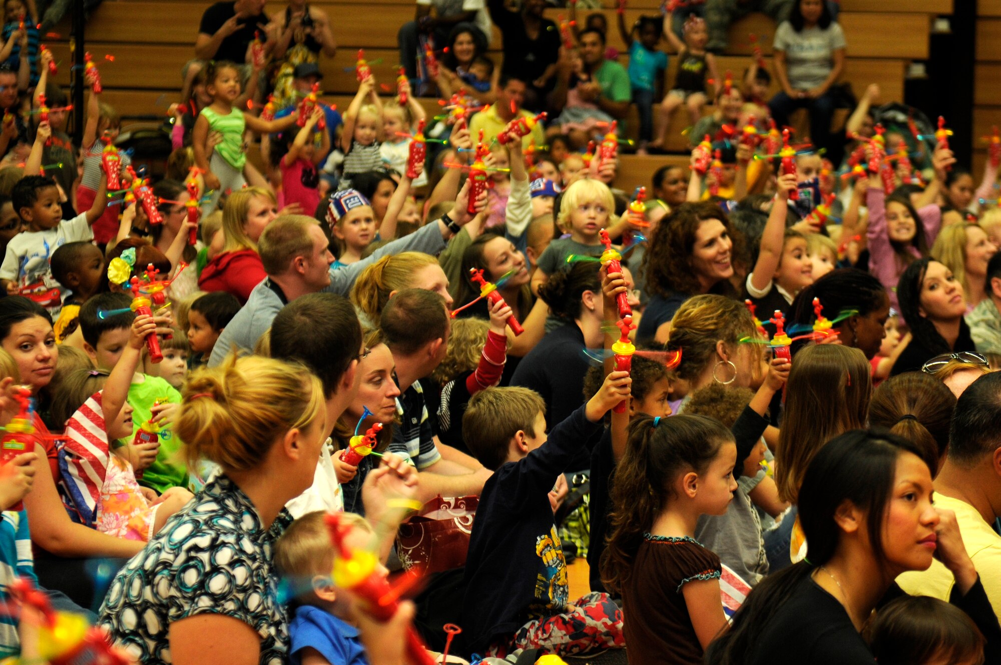 SPANGDAHLEM AIR BASE, Germany -- Military members and their families watch Sesame Street characters perform here during the Sesame Street/USO Experience for Military Families tour Sept. 2 at the Skelton Memorial Fitness Center. Elmo and his Sesame Street pals perform at installations all around the world. The tour focuses on the challenges families face during deployments. (U.S. Air Force photo/Airman 1st Class Brittney Frees)