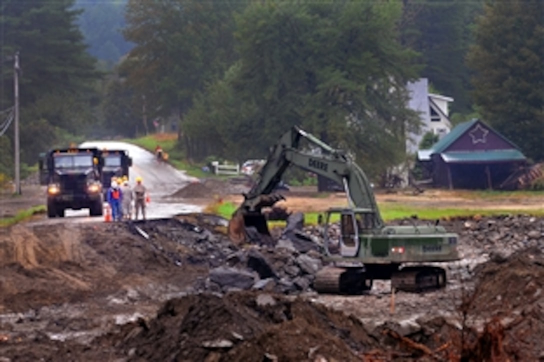 Maine National Guard soldiers work into the evening to rebuild Route 107 in Vermont, Sept. 5, 2011. Flooding that followed Hurricane Irene washed away the road.