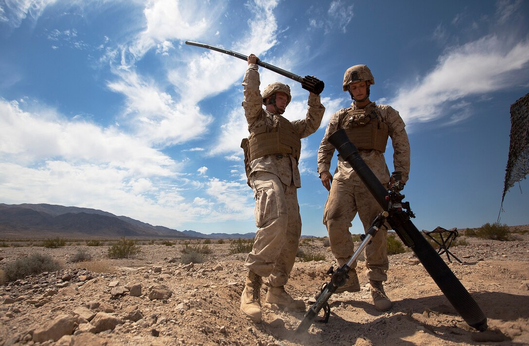 Lance Cpls. Justin Turner and Phil Schiffman, mortarmen with Weapons Company, 3rd Battalion, 3rd Marine Regiment, punch the bore of an 81mm mortar tube during a fire support coordination exercise on Marine Corps Air Ground Combat Center Twentynine Palms, Calif., Aug. 6, 2011. The evolution was part of the battalion’s 35-day Enhanced Mojave Viper training exercise. During EMV, the Marines of ‘America’s Battalion’ are training to kill enemy fighters by practicing counterinsurgency operations with supporting arms, aviation and logistics units. They are preparing for a fall deployment to Afghanistan’s Helmand province in support of Operation Enduring Freedom. Turner, 21, is from Flower Mound, Texas. Schiffman, 22, is from Phoenix. (Official U.S. Marine Corps photo by Cpl. Reece Lodder / RELEASED)