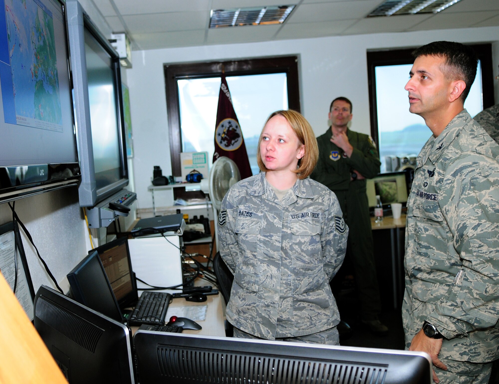 Tech. Sgt. Sandy Bates, 52nd Operations Support Squadron weather technician, tells Col. David Julazadah, 52nd Fighter Wing vice commander about the weather coverage provided by the 52nd OSS weather flight here Aug. 18. Colonel Julazadah visited the 52nd OSS as part of a familiarization tour where he spoke face-to-face with Saber Airman about what they do to provide combat power and deliver full spectrum support to the Air Force. (U.S. Air Force photo/Airman 1st Class Matthew B. Fredericks)