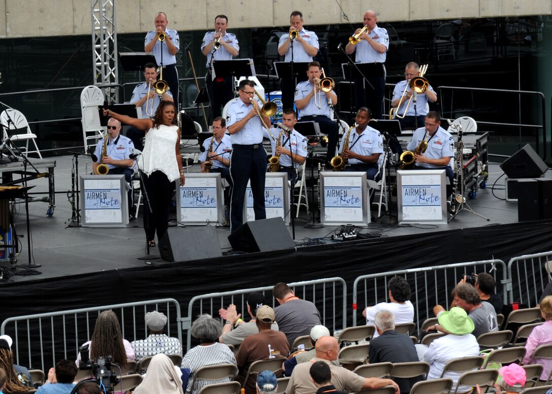 Retired Master Sgt. Tracey Wright, vocalist, and Senior Master Sgt. Joe Jackson, Airmen of Note trombonist and lead musical director, take center stage during a performance at the 2011 Detroit Jazz Festival on Sept. 4 in Detroit. The Airmen of Note performed at the festival for the first time in approximately 18 years. The Airmen of Note festival performance also featured vibraphonist Joe Locke. (U.S. Air Force photo/ Airman 1st Class Bahja J. Jones)  