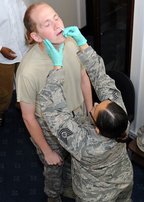 RAF MILDENHALL, England -- Tech. Sgt. Gina Bolton, 488th Intelligence Squadron flight medical staff, administers FluMist to Senior Airman Lance McDaniel, 100th Operations Group intelligence journeyman, at Building 239 here Sept. 7, 2011.  The flight medical staff will be appearing at different base locations periodically to administer flu vaccines, which are mandatory for all military members.  (U.S. Air Force photo/Staff Sgt. Tabitha M. Lee)