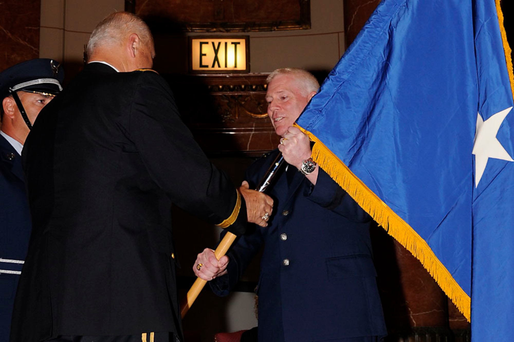 Brig. Gen Jeffrey Hauser accepts a one-star flag from Maj. Gen. R. Martin Umbarger.  Photo by Master Sgt. John Day