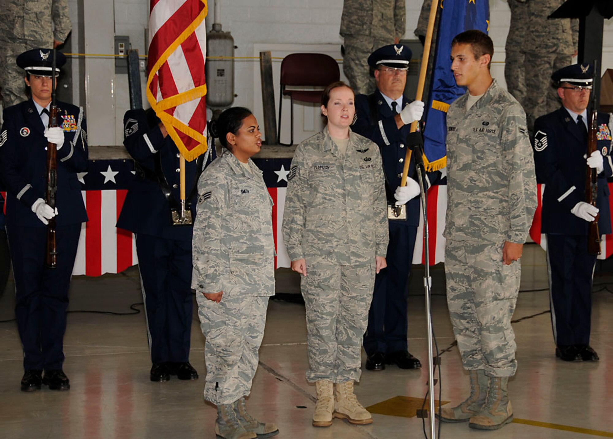 Base Honor Guard presents the colors while the National Anthem is sung by the Racer Trio. Photo by Master Sgt. John Day