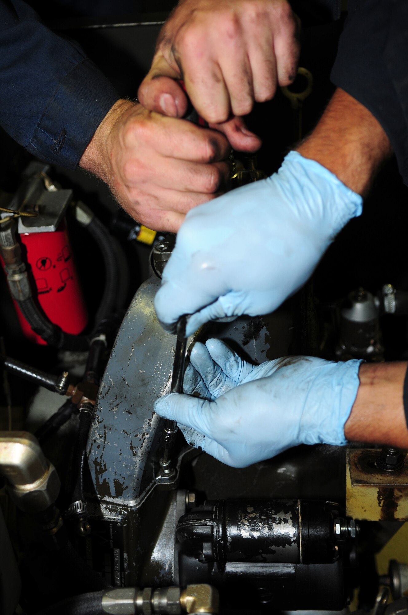 SPANGDAHLEM AIR BASE, Germany – Airmen from the 52nd Equipment Maintenance Squadron Aerospace Ground Equipment Flight work to replace the engine head assembly on an MC2A low-pressure air compressor here Sept. 6. The aerospace ground equipment flight is responsible for providing and maintaining both powered and non-powered AGE to support the 52nd Fighter Wing’s flying operations. (U.S. Air Force photo/Airman 1st Class Matthew B. Fredericks)